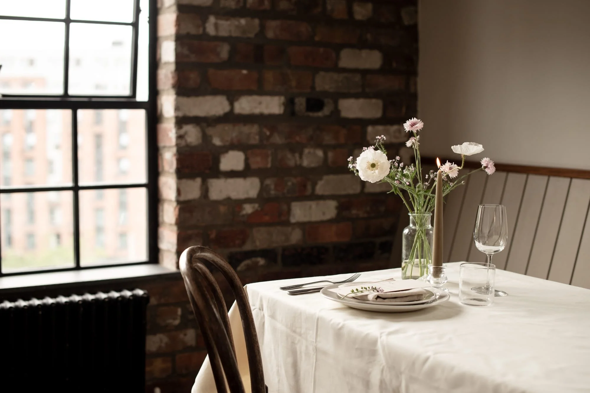 The Kitchen Studio at The Forge Bristol set for an intimate private gathering with flowers and table styling