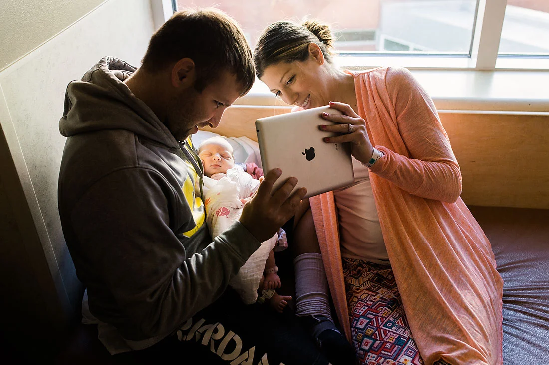 Parents showing off their new baby girl to family on facetime