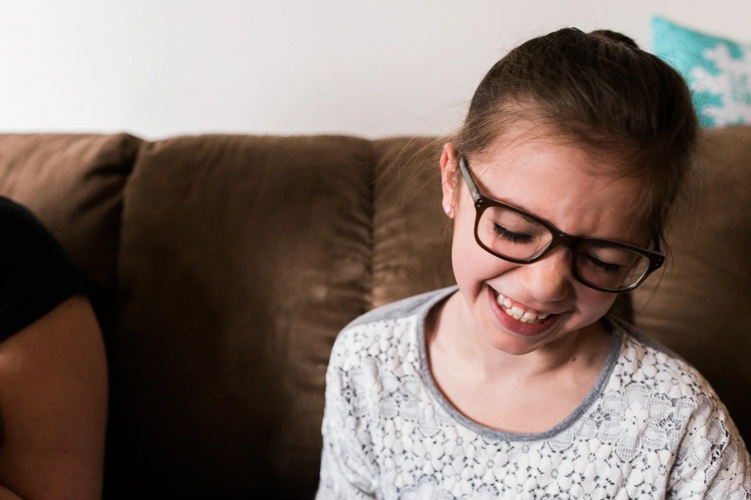 child giggling with her family