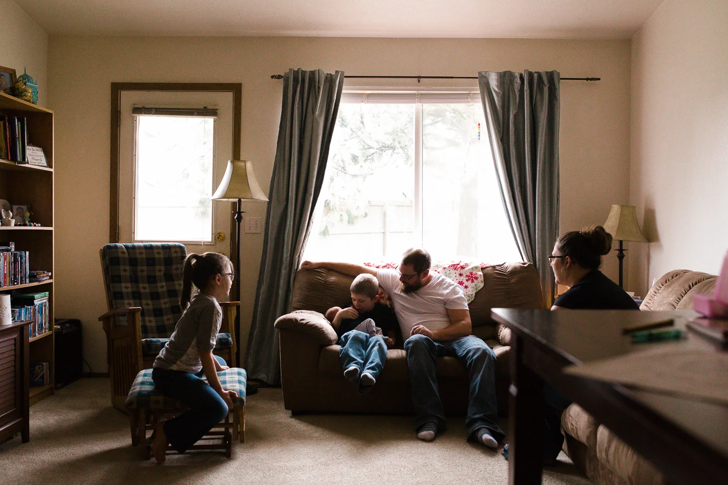 family gathering together in their living room