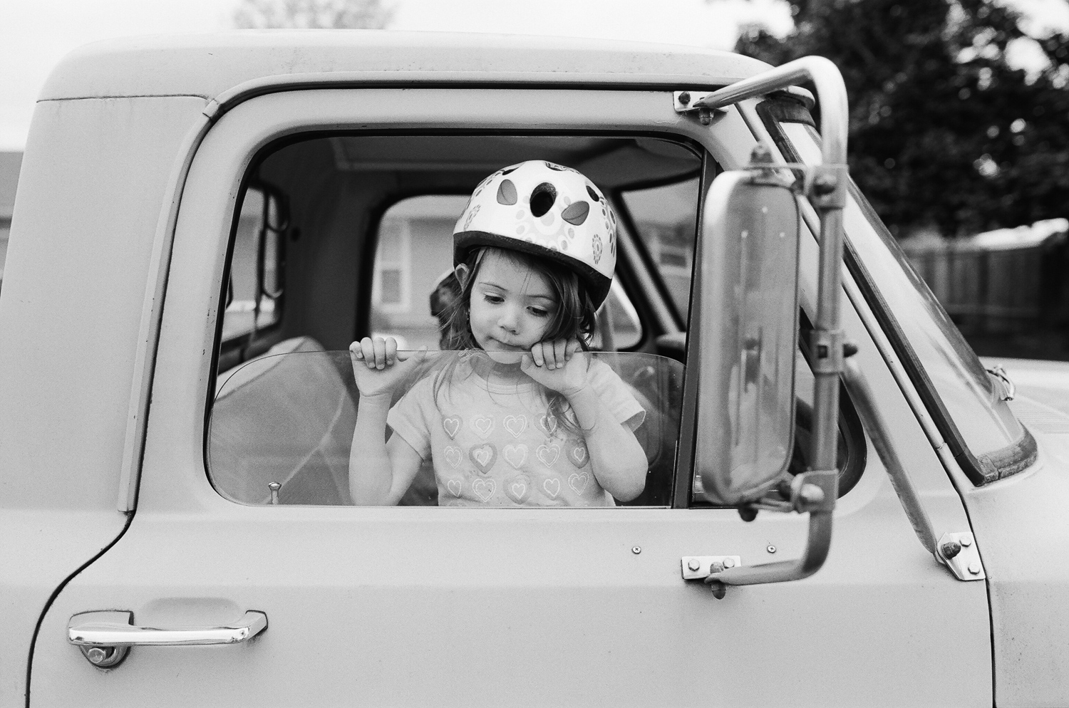 girl playing in her dad's truck