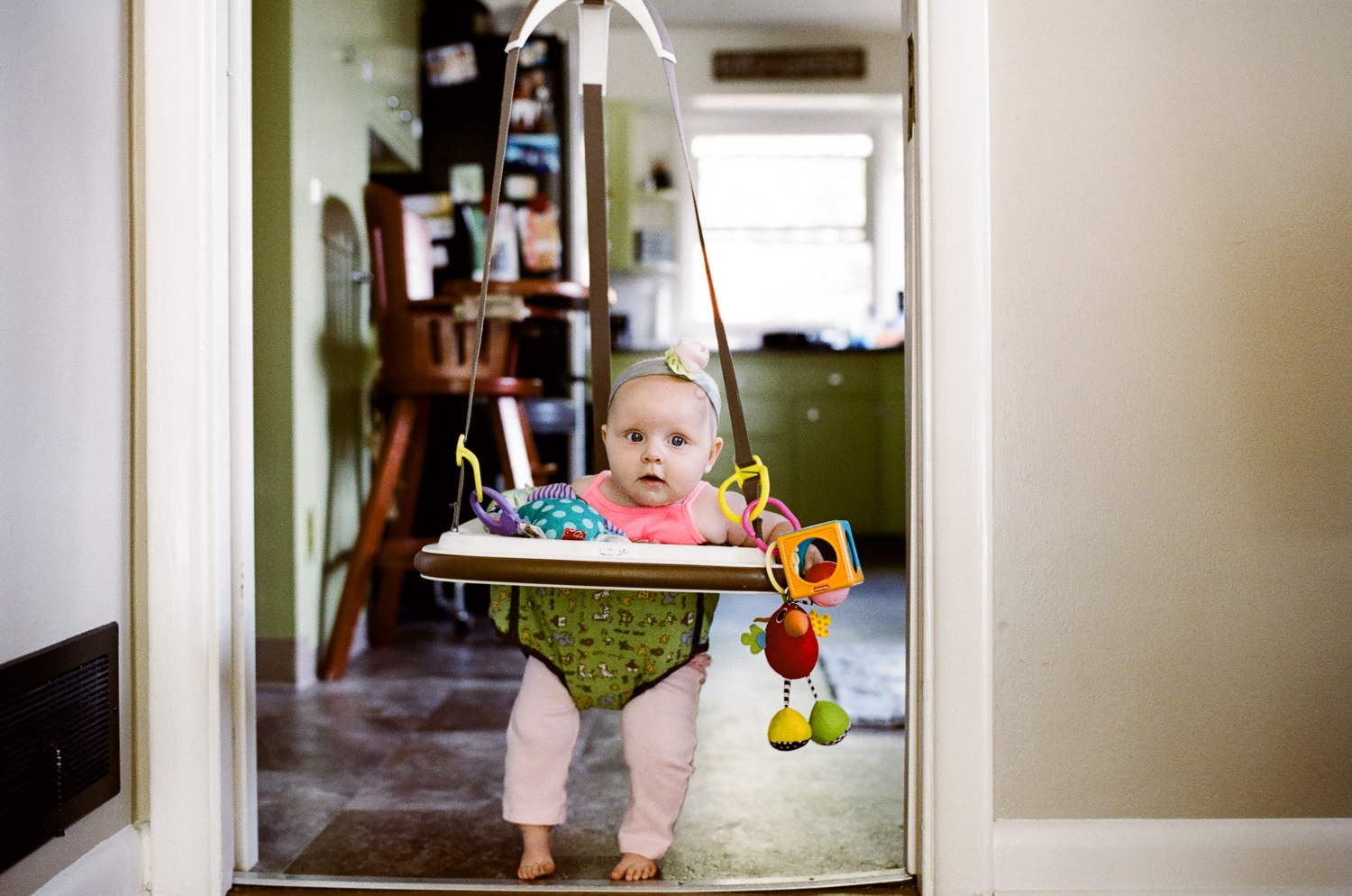 baby in green bouncer