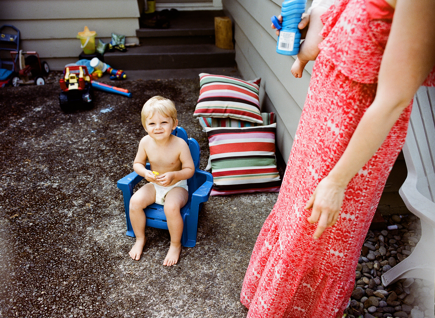 boy playing with bubbles in backyard