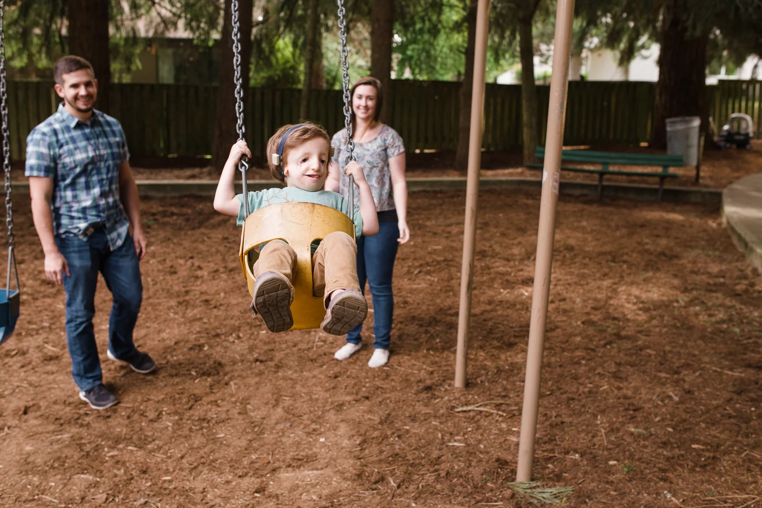 boy swinging on a yellow swing