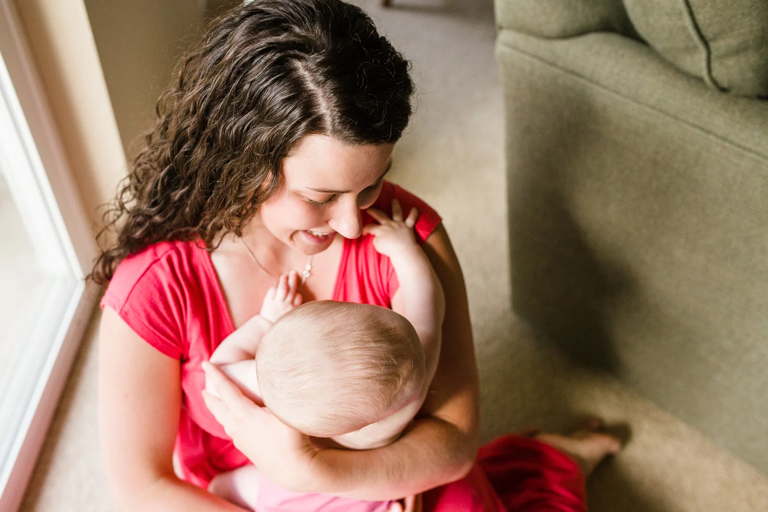 mom embracing infant daughter
