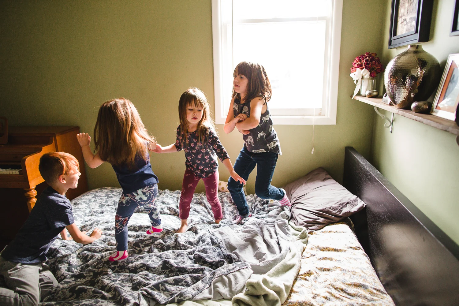family jumping on bed