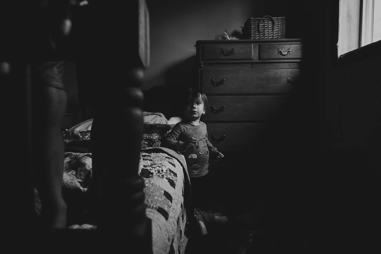 toddler boy climbing on bed