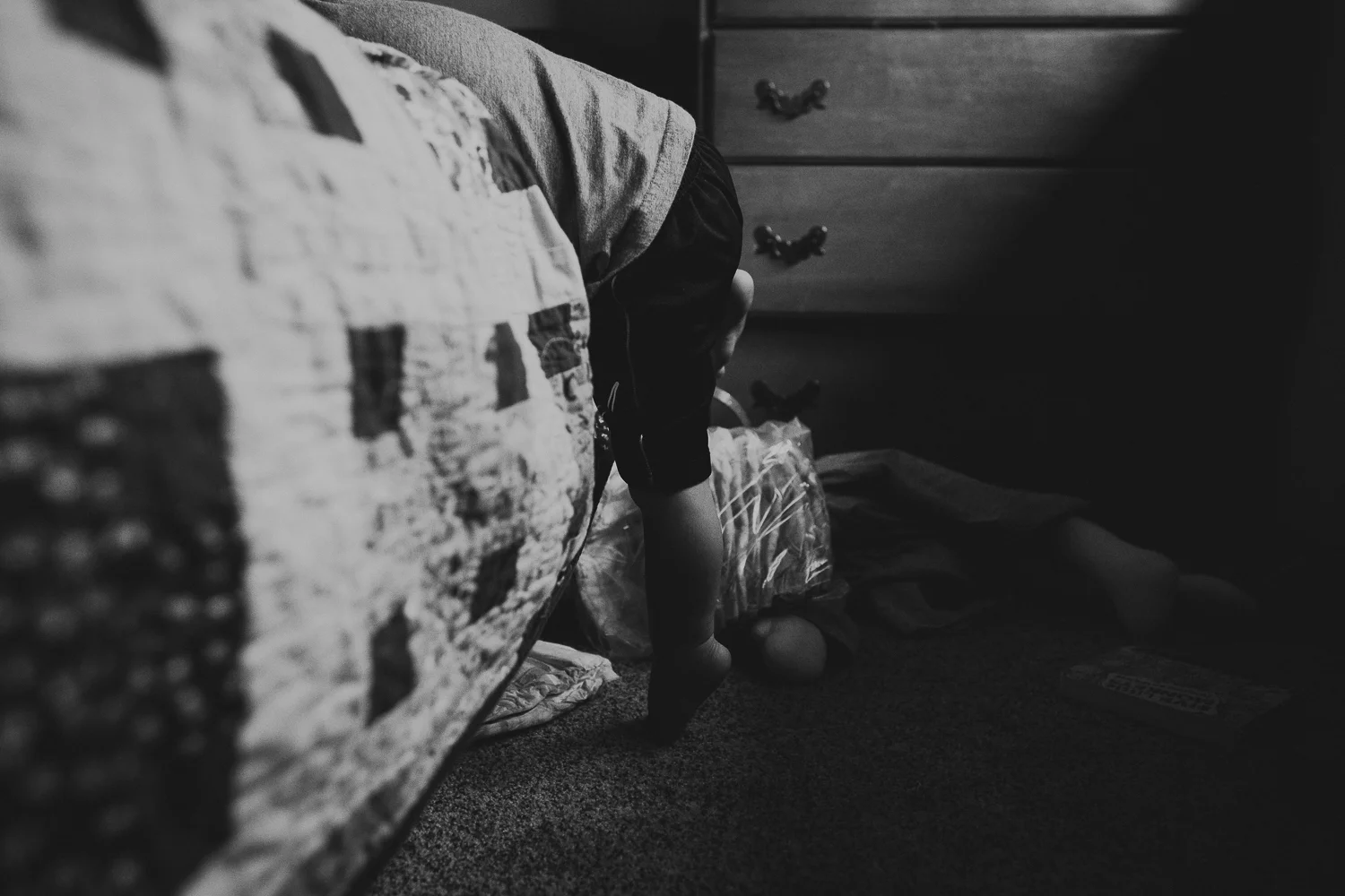 toddler boy climbing on bed