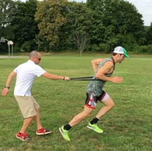 Coach Dave, and Theo, working on body position and foot-strike via tow-out drills.