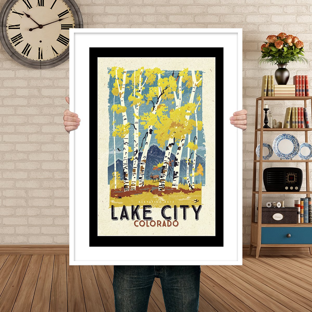 Man Holding Poster Mockup Lake City Fall.jpg