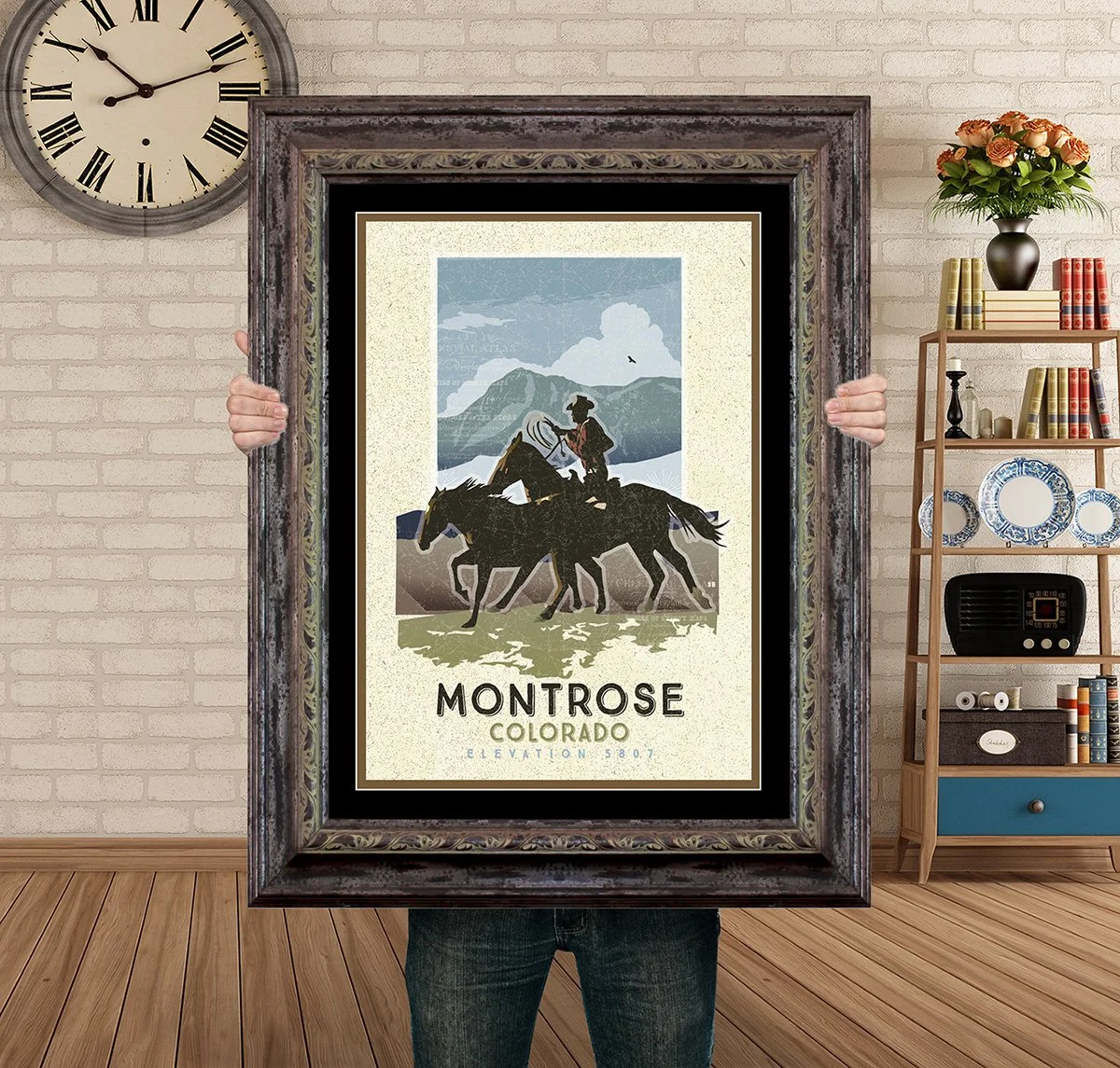 Man Holding Poster Mockup Barnwood Peach Valley Montrose rouundup.jpg