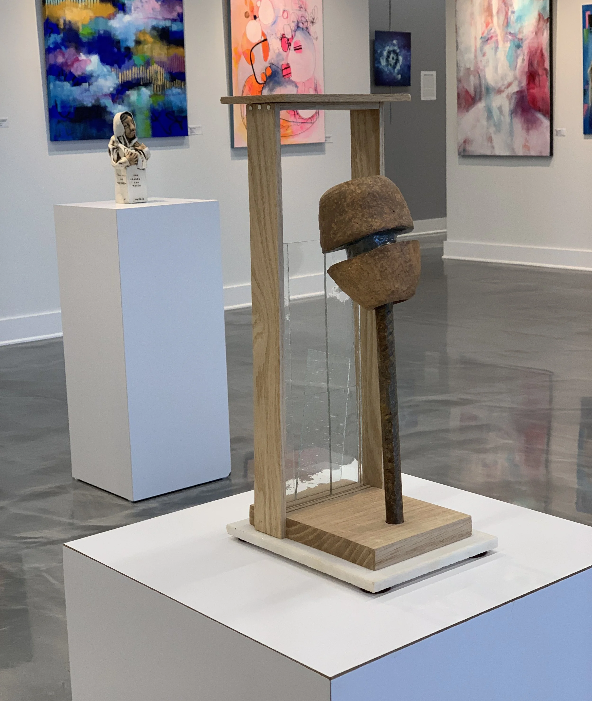 Sculpture by Norman Silva, "Stalled Impetus." It is made of wood, glass, steel and ceramic.