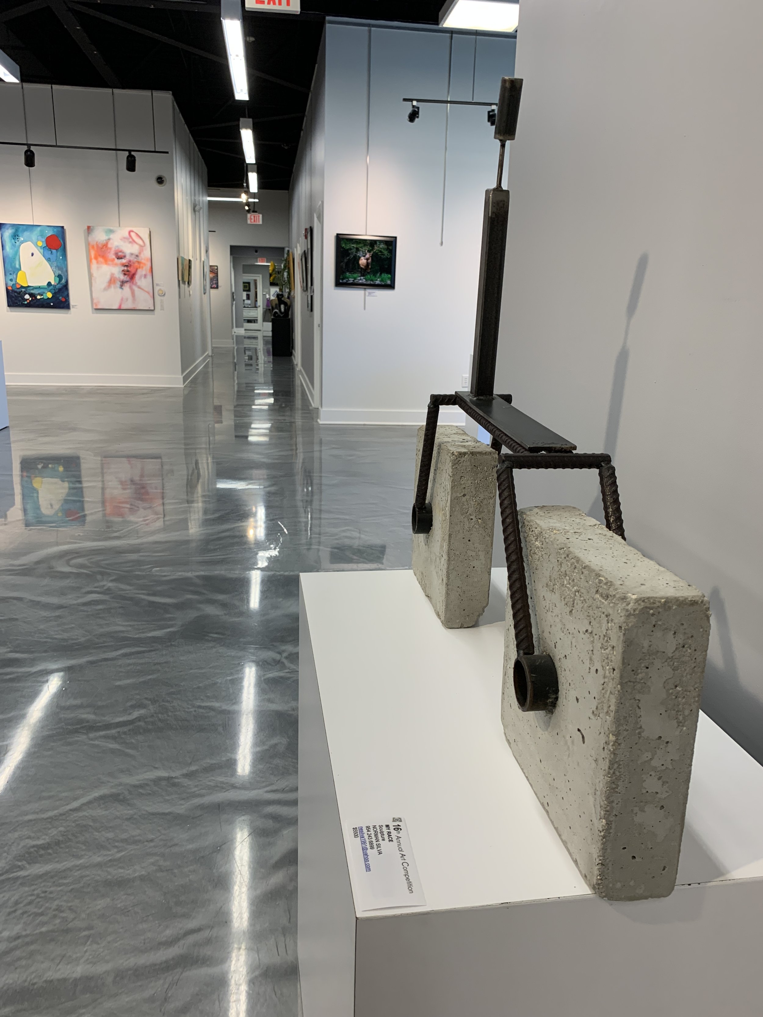 Norman Silva's sculpture, "My Race." It is made of concrete, and steel.