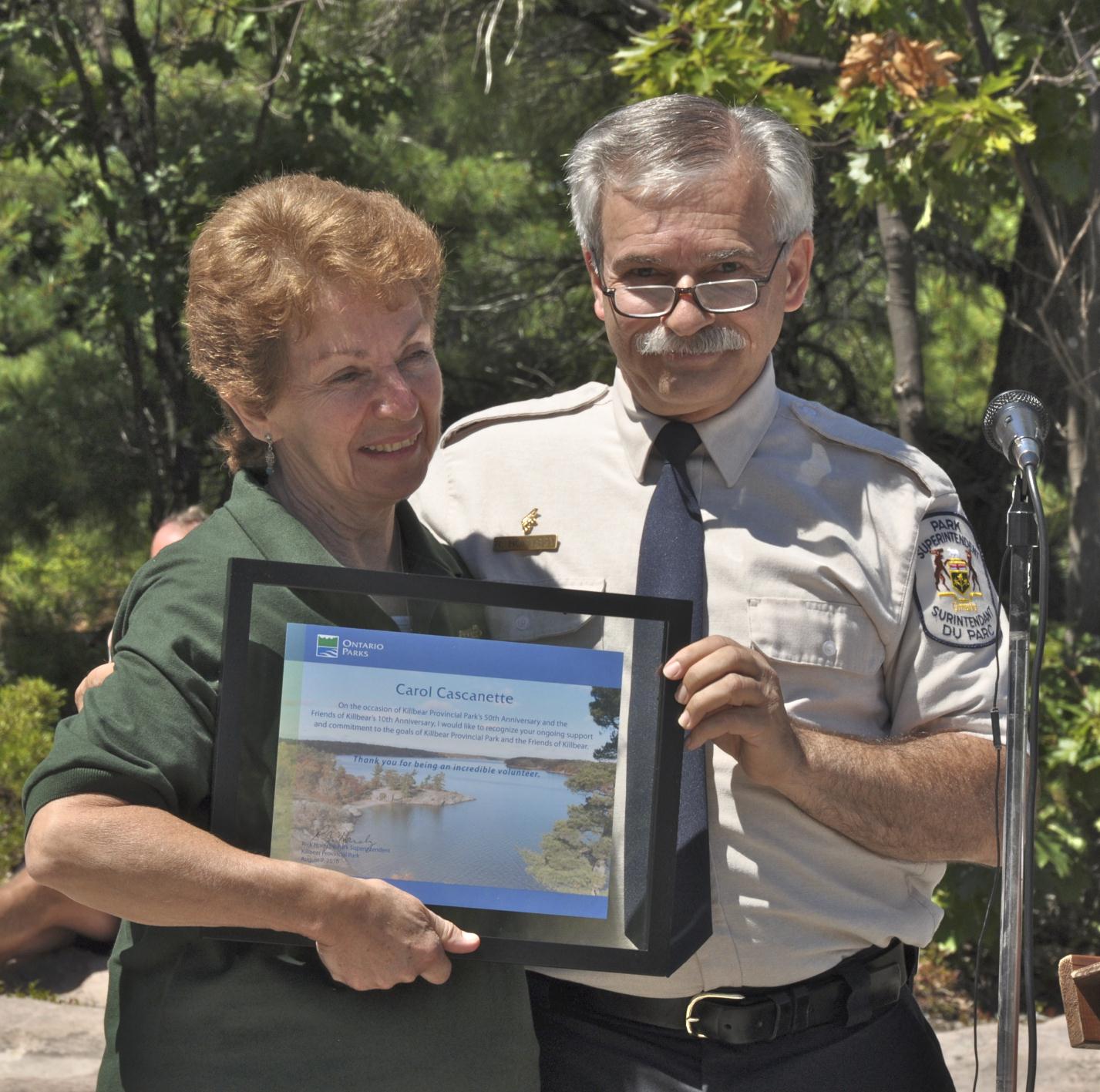 Carol Cascanette receiving award from Superintendent Rick Hornsby at Killbear's 50th Anniversary Party.