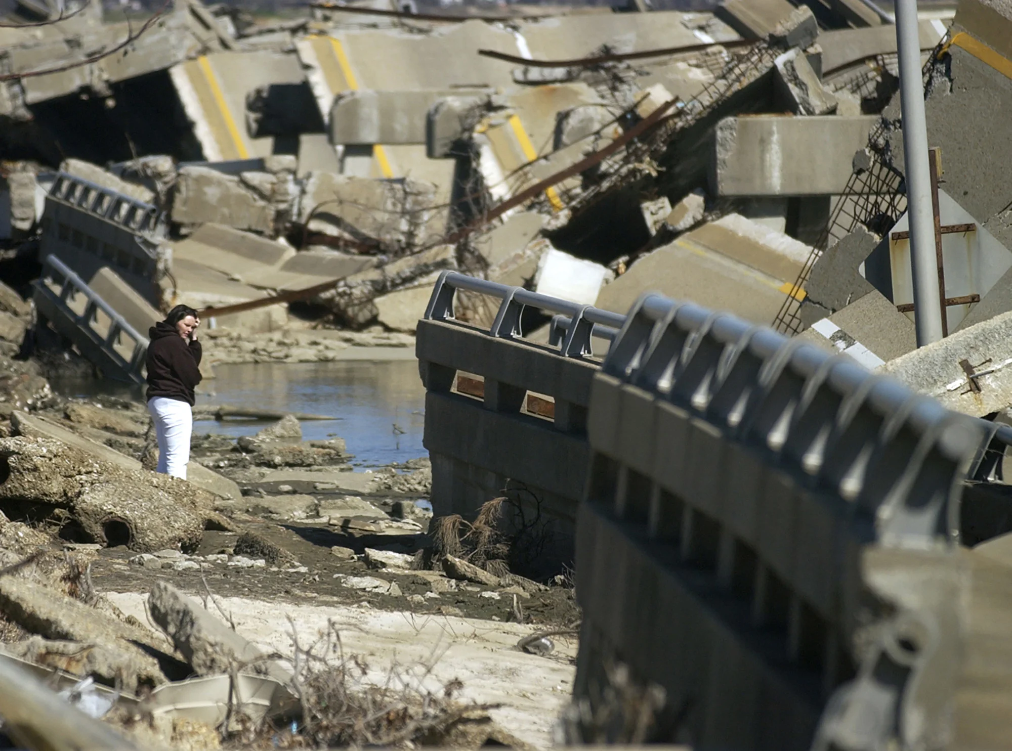Stephanie Morgan, of Hattiesburg, Miss., surveys Hurricane Katrina damage to the Biloxi Bay Bridge in Biloxi, Miss. More than 100 miles of U.S. Highway 90 between Pascagoula, Miss. and New Orleans were destroyed by Katrina, including the Biloxi Bay Bridge, which connected the communities of Ocean Shores and Biloxi. (Tyler Sipe / Traverse City Record-Eagle)