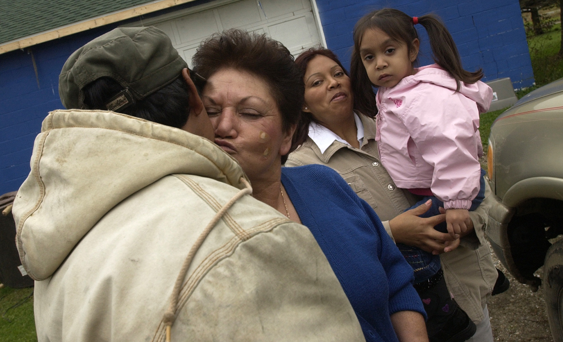 Juleo Ramos, a documented resident immigrant, is greeted by family friend San Juanita Teeple, whom assisted Juleo's wife Lorena Ramos and daughter Emily Ramos, 3, with translation services at a doctor's office in Cadillac. Teeple grew up a migrant and now regularly assists Hispanics in the area with translation to overcome legal, medical, and societal barriers.