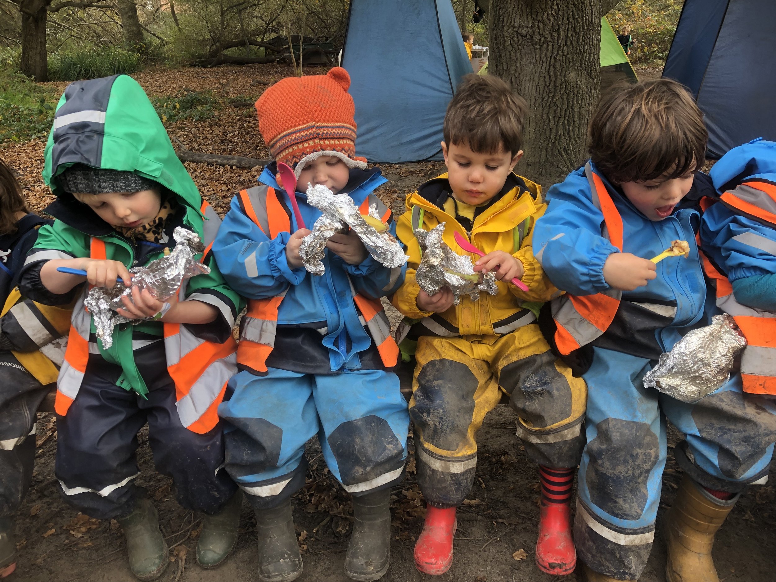 Children eating cooked bananas from the fire 2.jpg