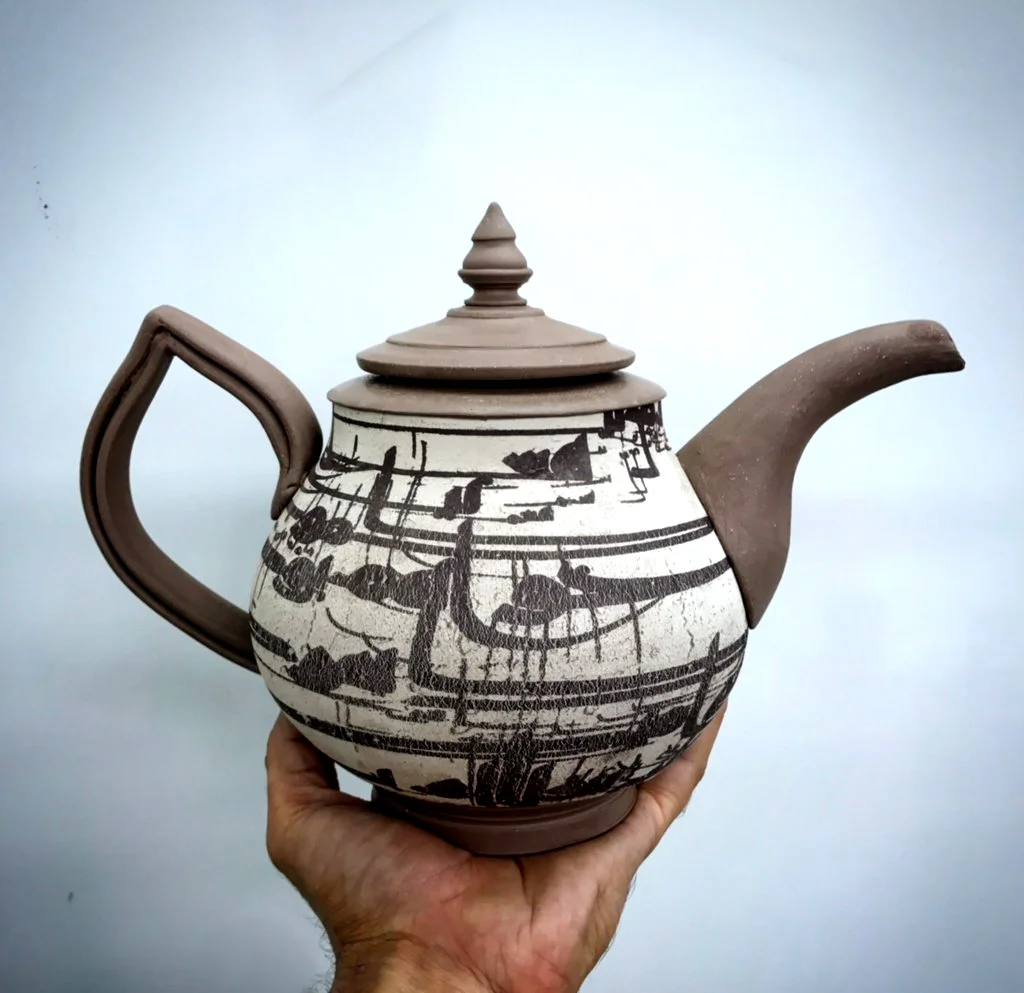 Teapot with transfer headed to the kiln
