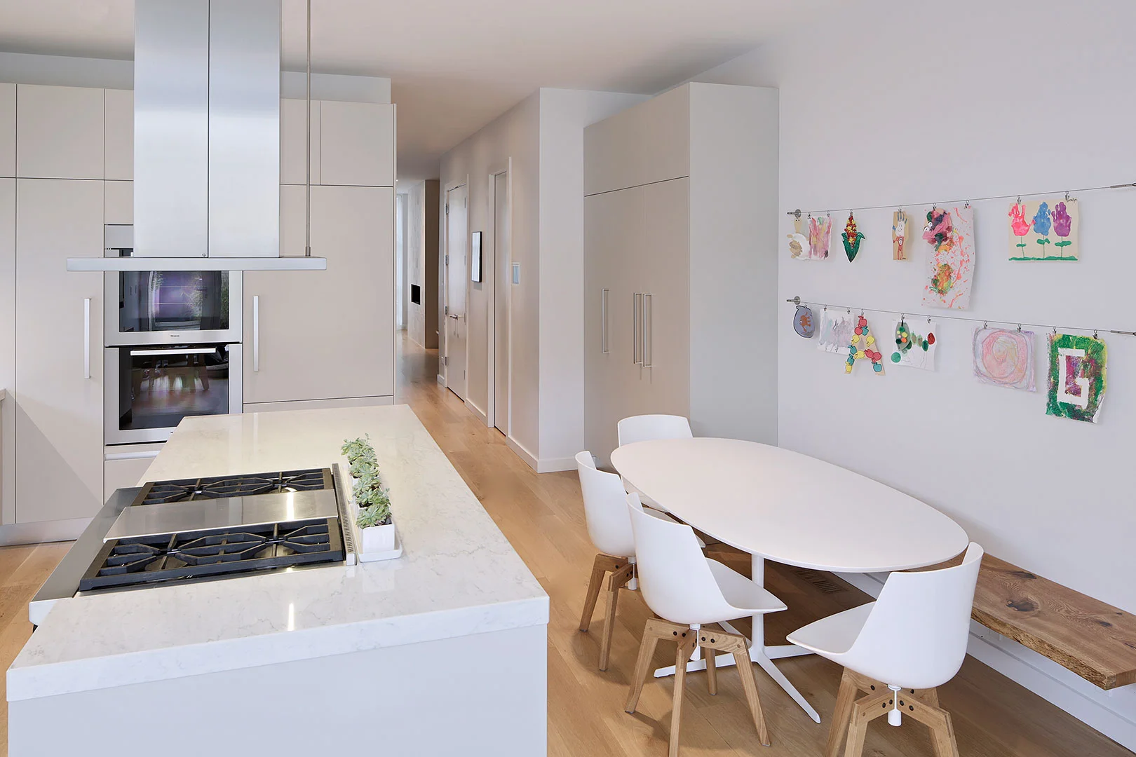 Single-Family Home Location: Chicago, IL Photos: Marty Peters Project Description: “Silver & Zinc” For this residence, natural light and continued spatial flow was vital for its narrow urban location. Allowing natural light to penetrate the interiors of the residence while providing privacy was essential. The solution was to create open, fluid interior spaces with openings on the southern side for directing daylight. The exteriors material palette of cast-in-place concrete and vertical ebony zinc panels counters the lightness of the interior spaces. In some instances the exterior finishes find their way to the interiors, blurring the lines between the two. The residences roof consists of a private office overlooking a fully landscaped green roof environment. Added to this are large solar panels located on the upper roof, slightly out of sight from the street to keep in scale with the neighborhood. These important elements are part of a list of features that gave this residence a Silver Certification form LEED For Homes.