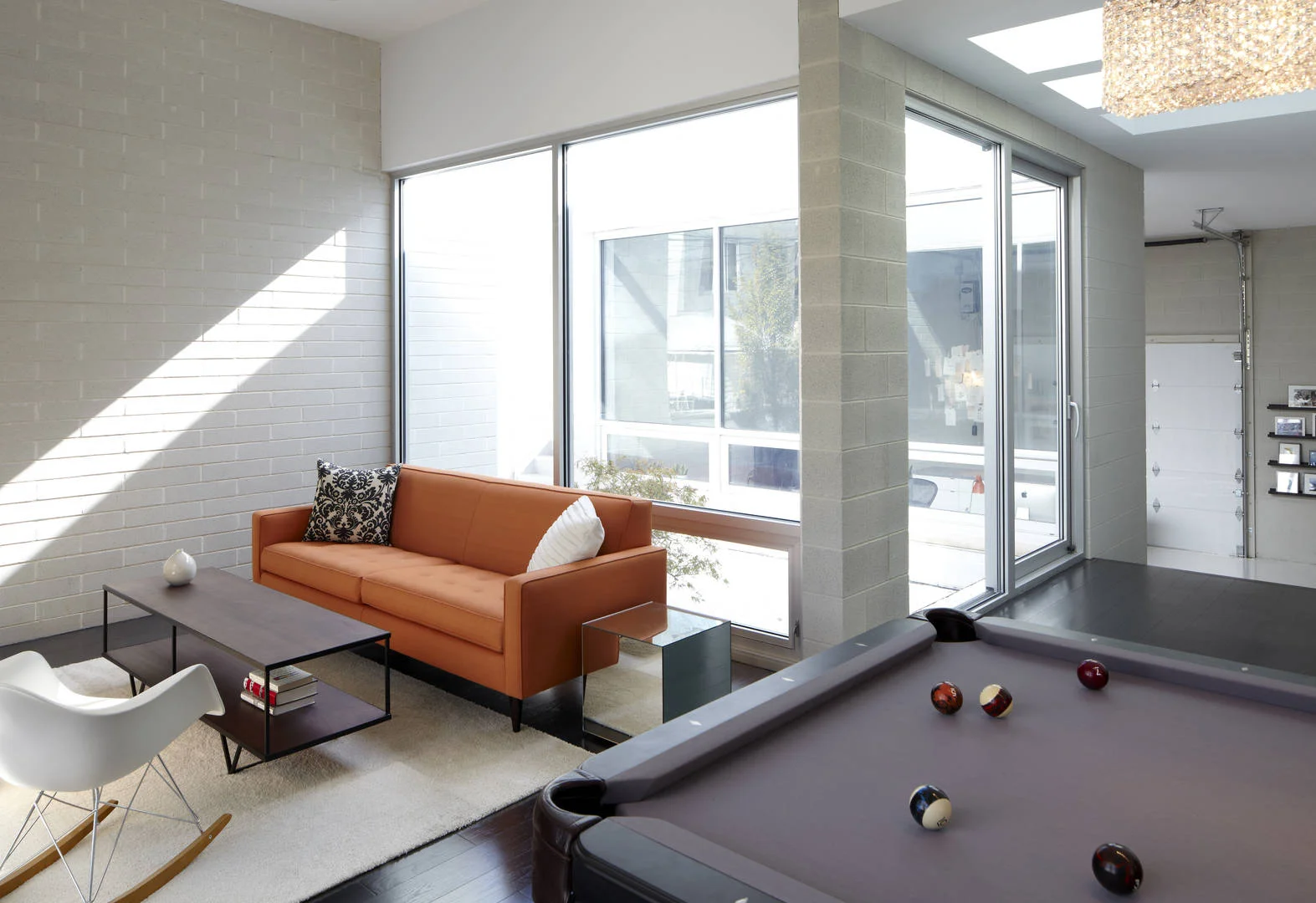 Single-Family Home Location: Chicago, IL Photos: Marty Peters “Unwavering Bands of Light” 2012 AIA Chicago Distinguished Building Award – Citation of Merit 2012 Builder’s Choice Award For this modern residence, the elements of light, transparency, and continuous spatial flow were vital. Privacy was also a concern since the residence is located in a tight urban location. The solution was to create open and fluid interior spaces both horizontally and vertically, and then to wrap it all in white masonry. This white veil is then scored with window bands that bring in abundant natural light, while their strategic locations provide privacy and eliminate the need for window treatments. The light-filled, modern white interior is strengthened by the use of reflective white surfaces and the use of glass railings. The main central stair is clad in both clear and opaque glass to further maintain privacy while bringing in natural light. The flowing and light filled interiors are carried to the two surrounding exterior landscapes, blurring the boundaries creating an urban retreat.