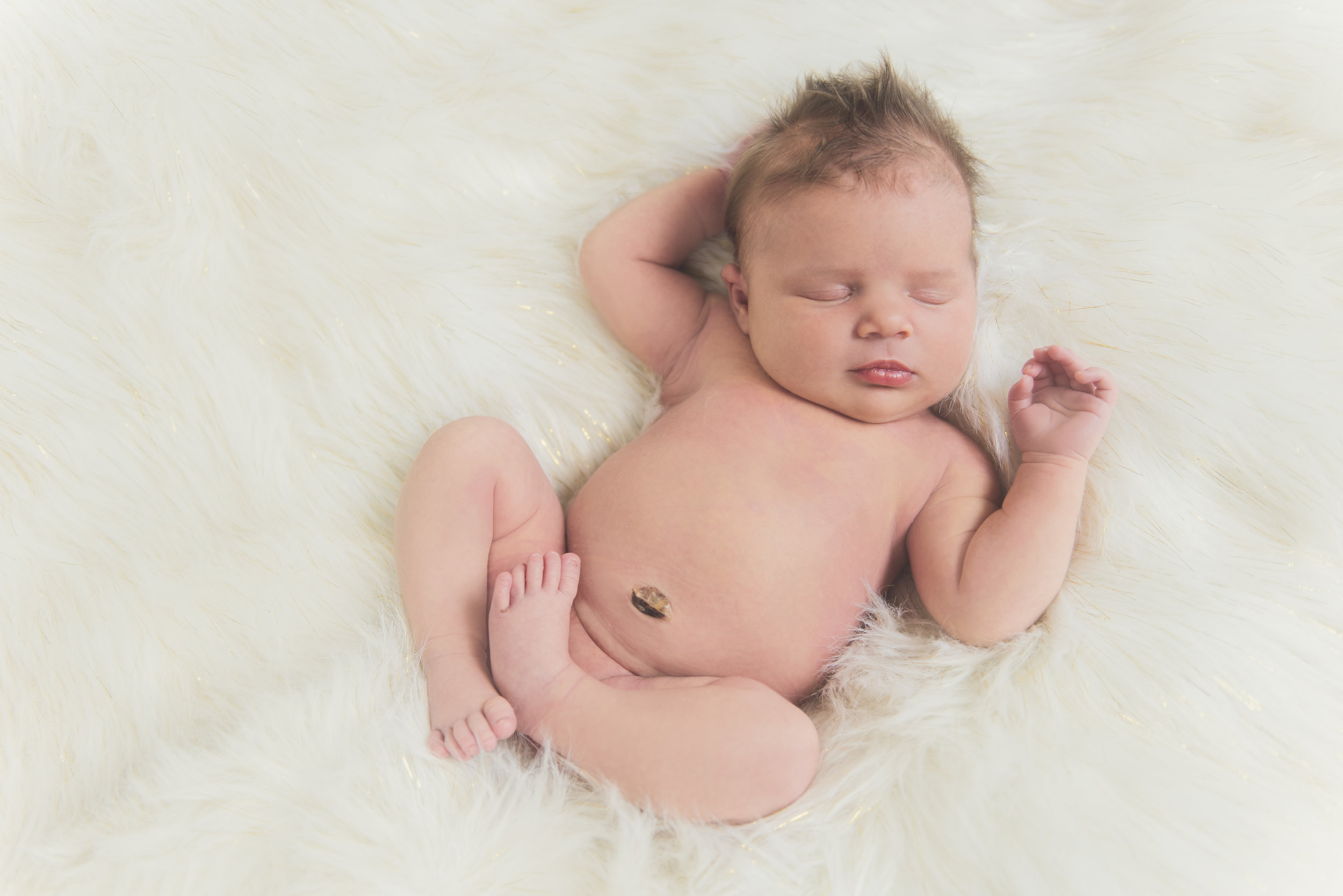 all natural naked newborn on fluffy rug