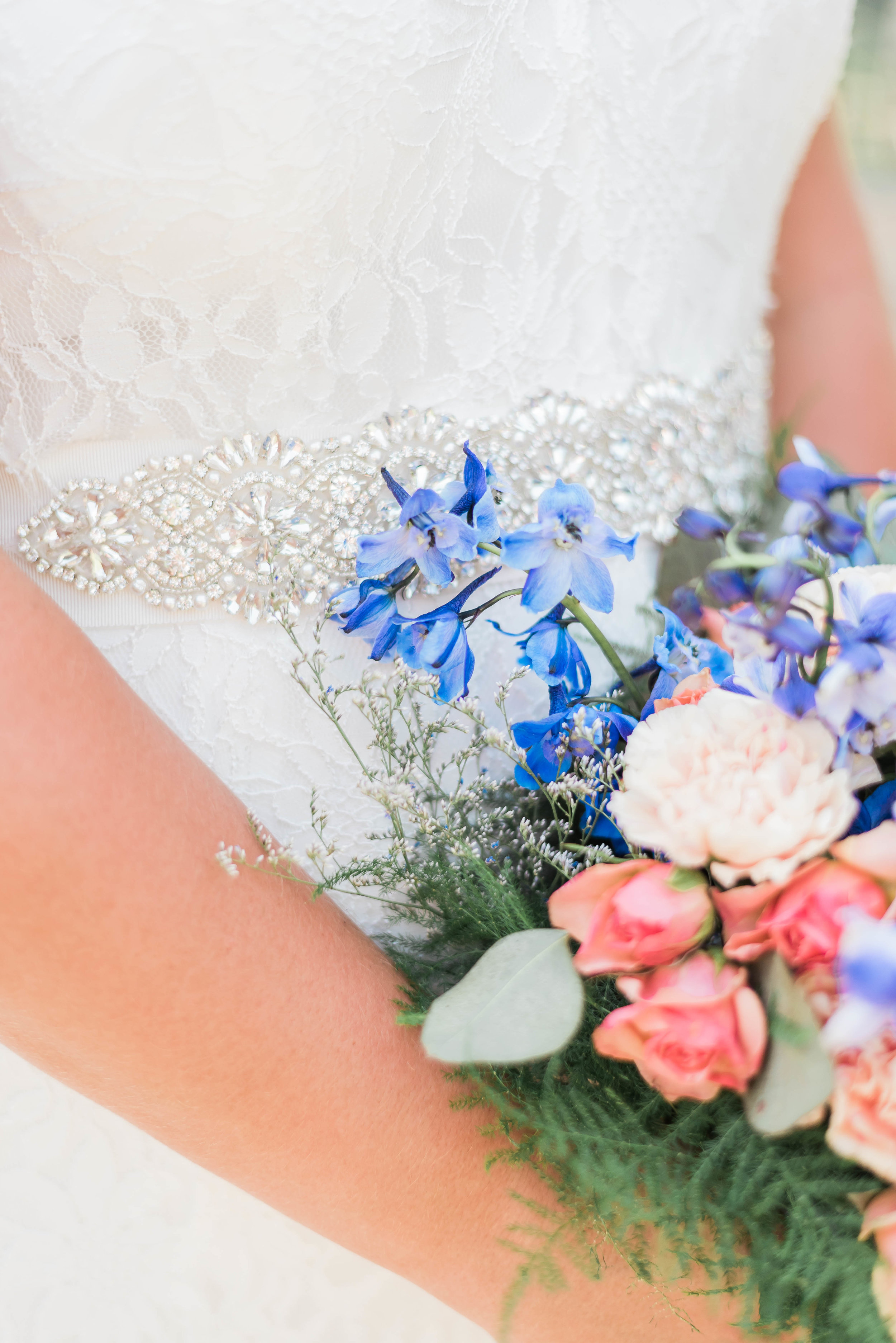 bride bouquet detail shot with dress