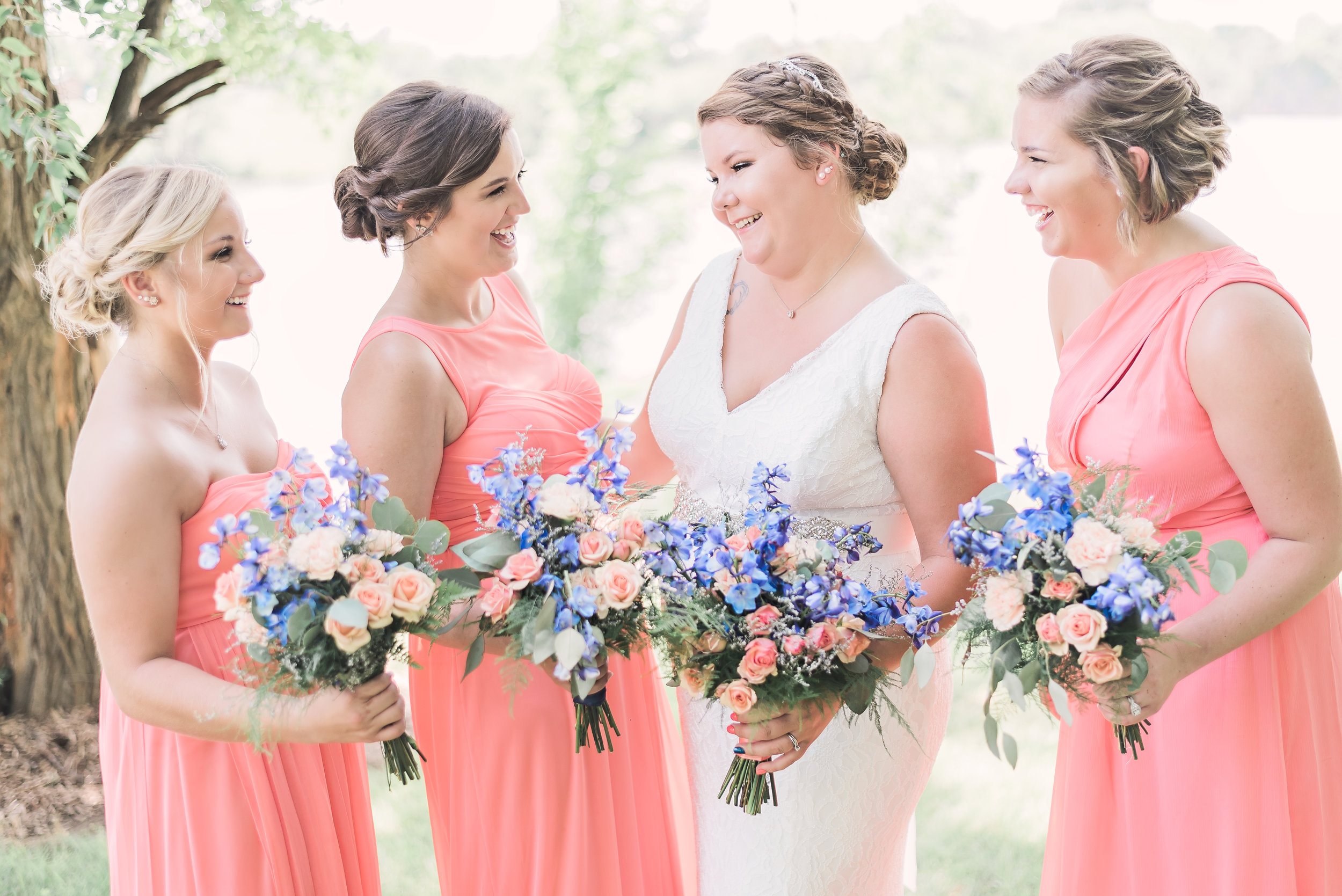 bridesmaids with bride laughing