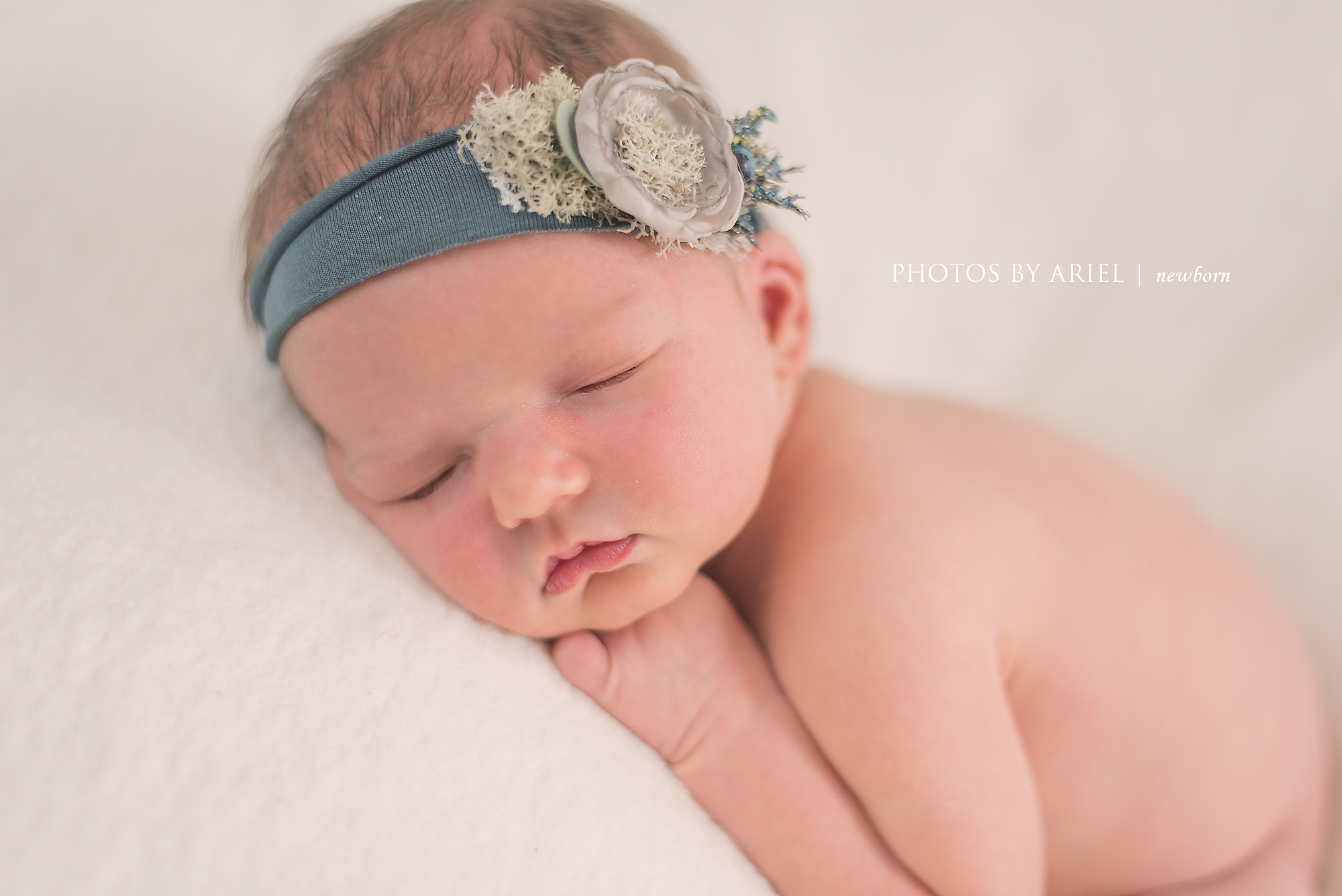 close up baby girl in blue headband