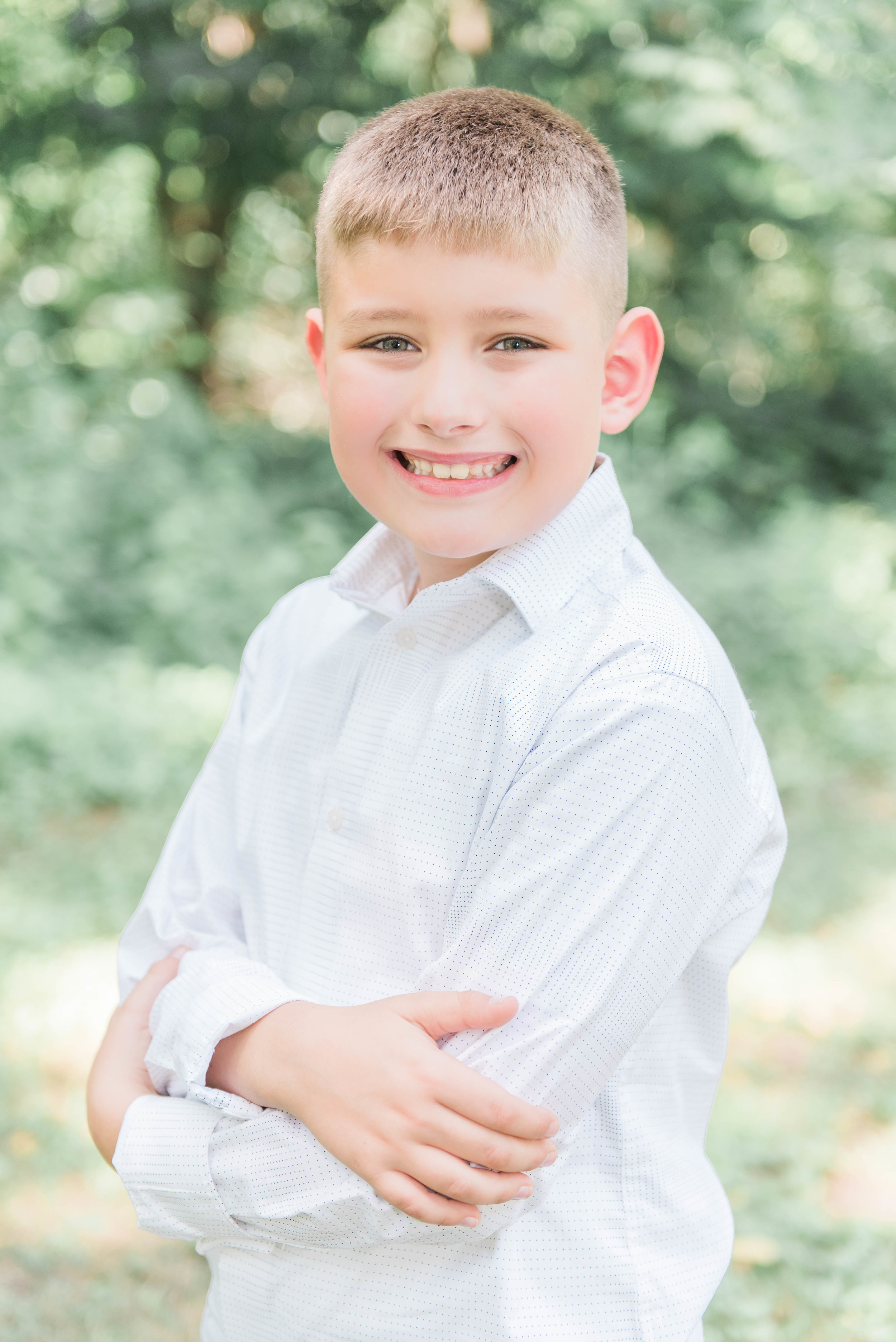 boy standing with arms crossed outside funks grove chapel