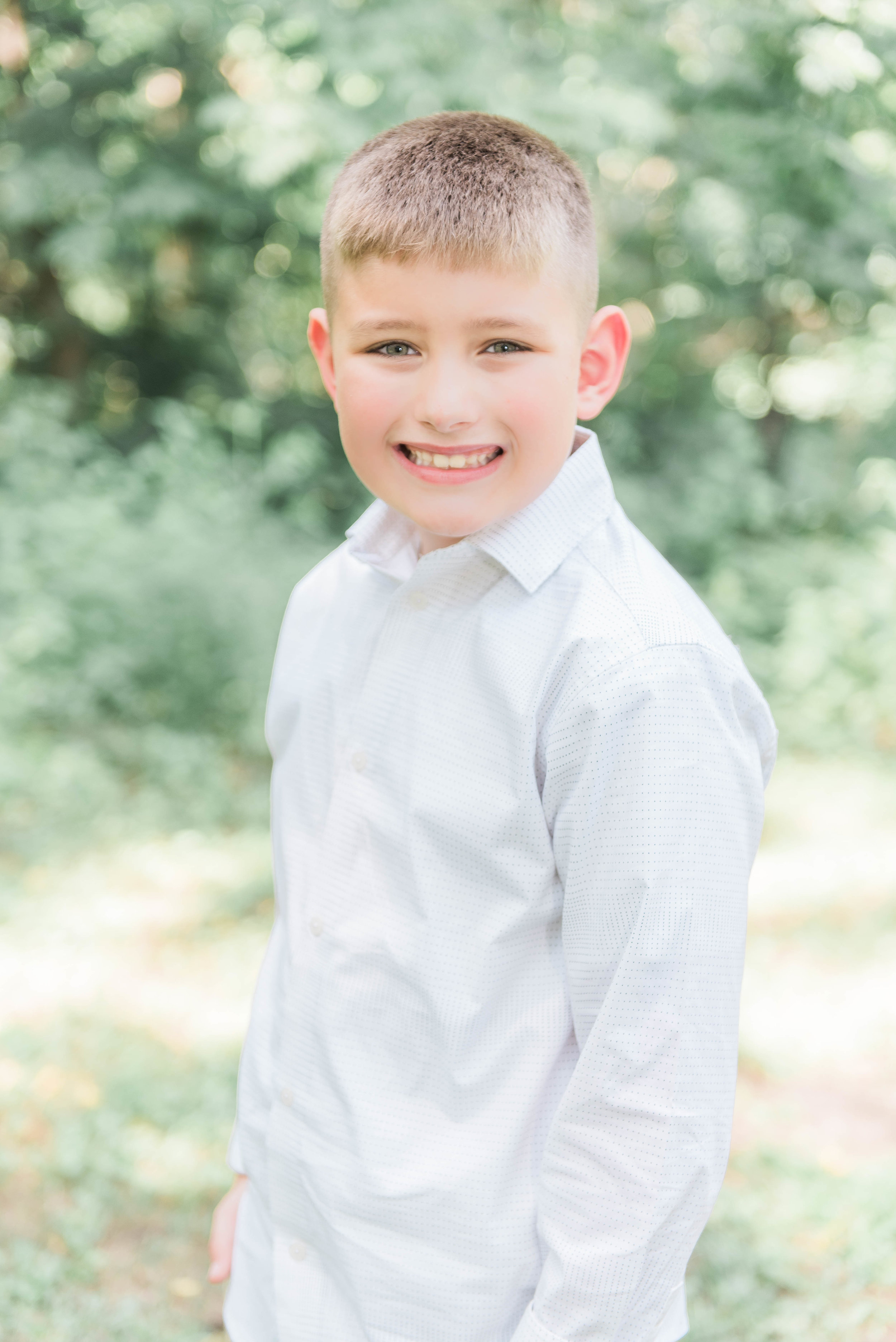 little boy hands in pocket pose outside funks grove white chapel