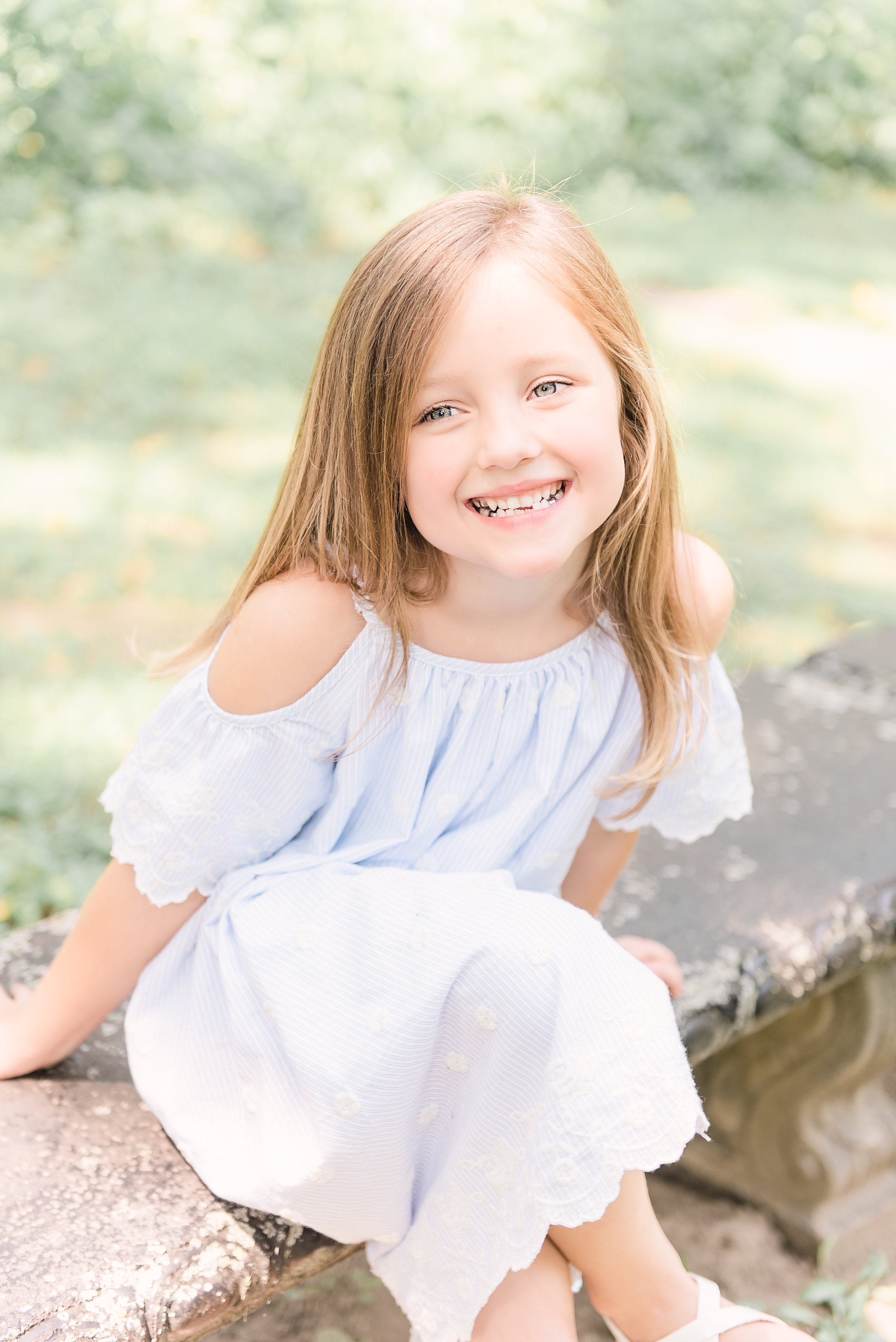 little girl on bench smiling and laughing funks grove chapel