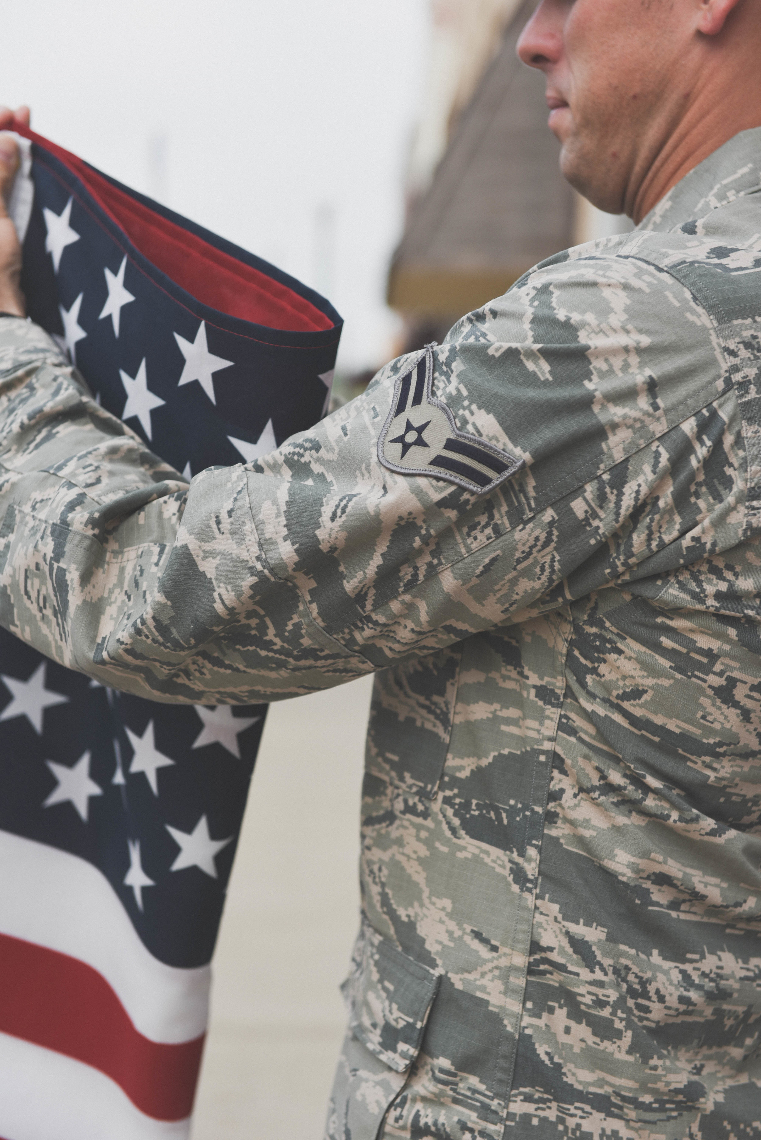 man folding flag