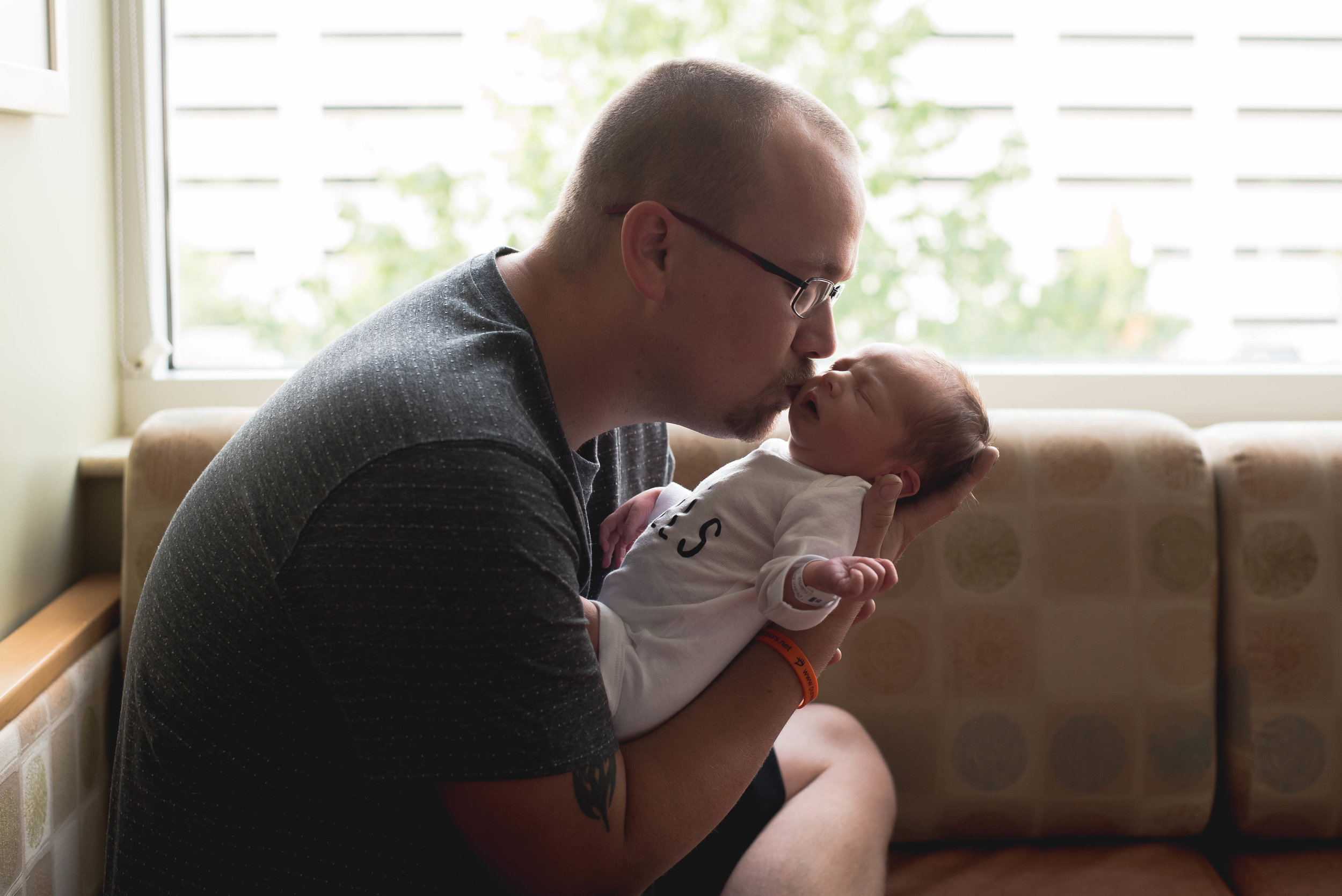 daddy kisses baby's nose