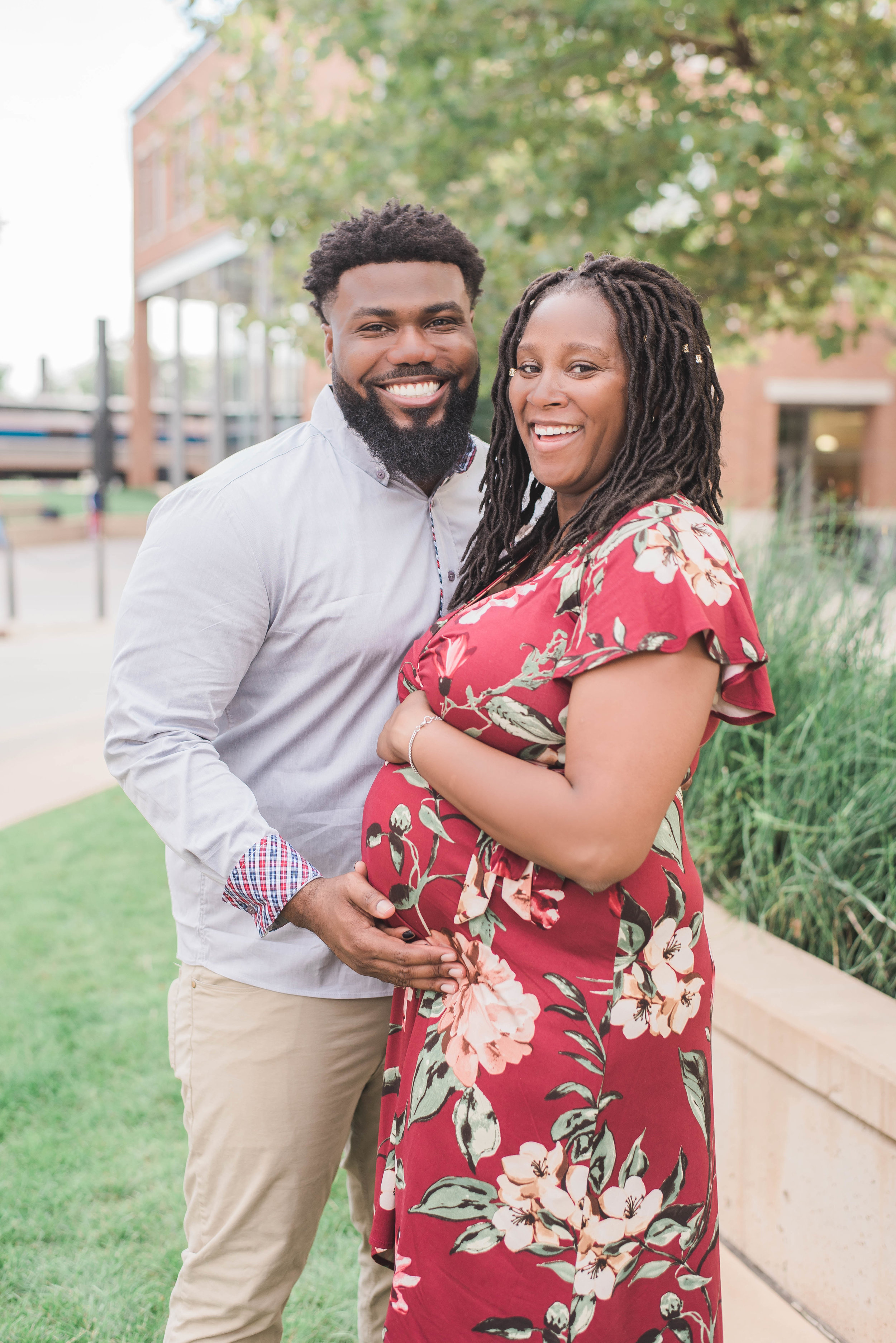 mom and dad in uptown circle maternity photo smiling