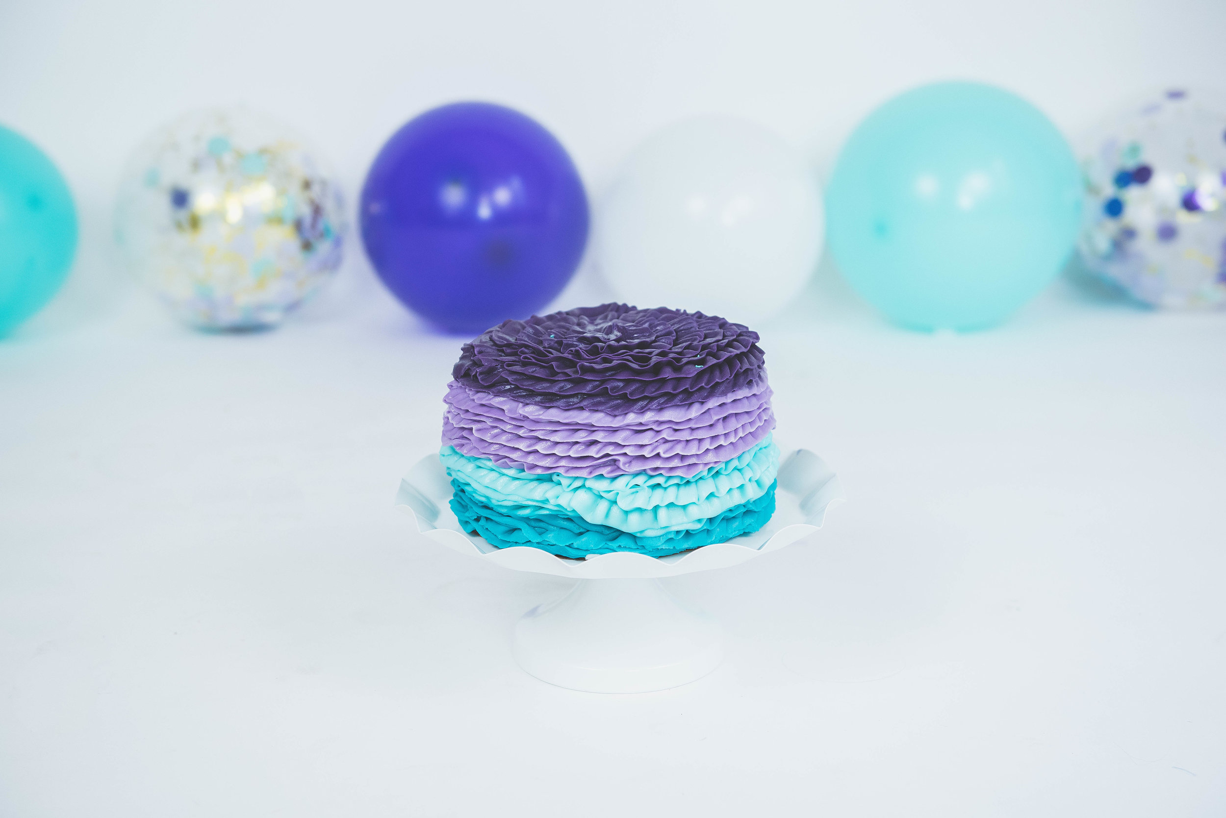 purple &amp; turquoise smash cake with decorations