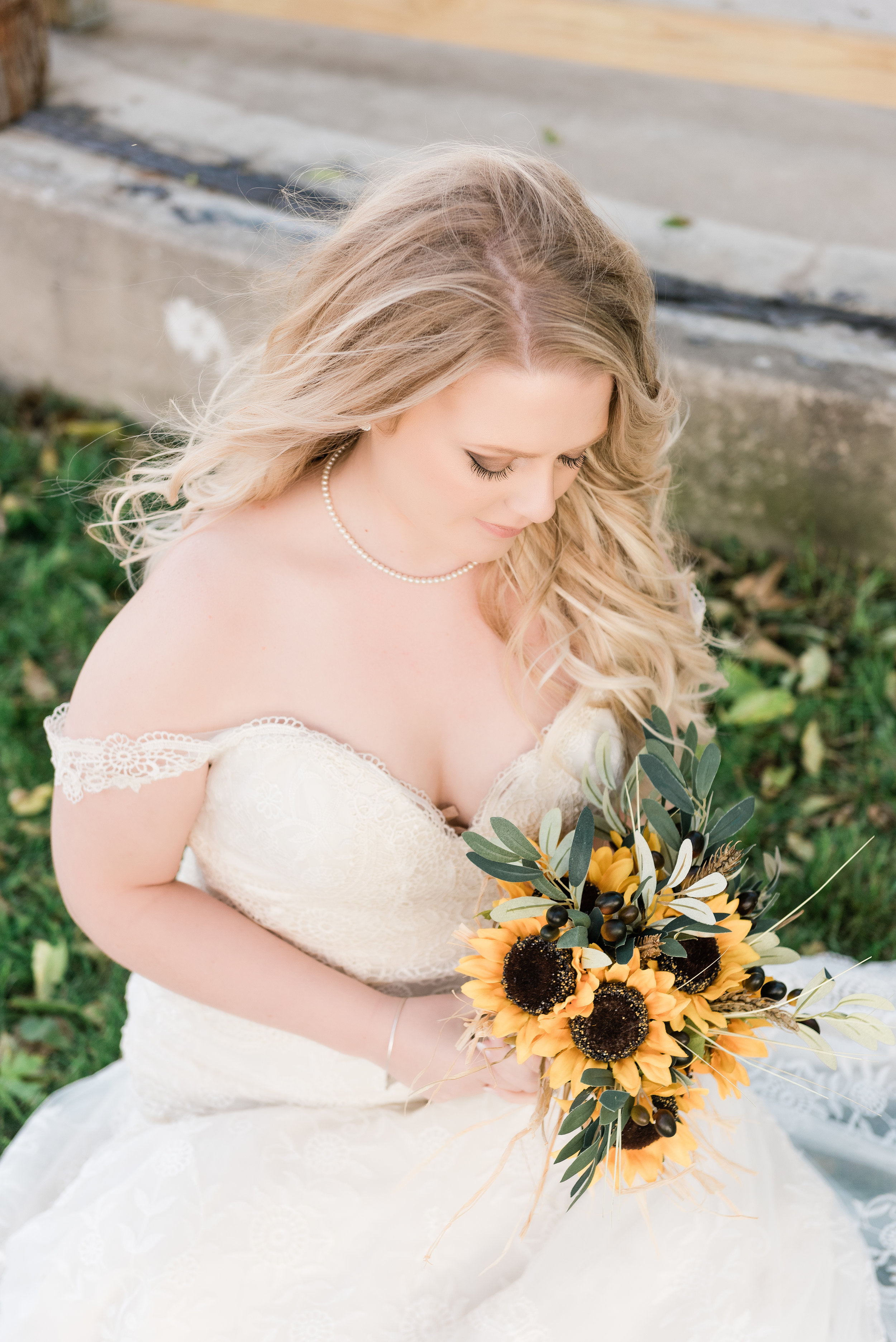 bride looking at bouquet