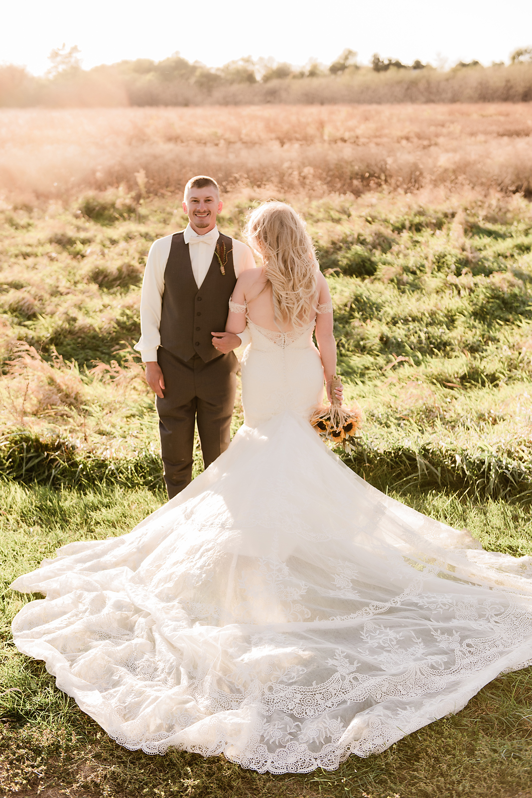 bride and groom in field 