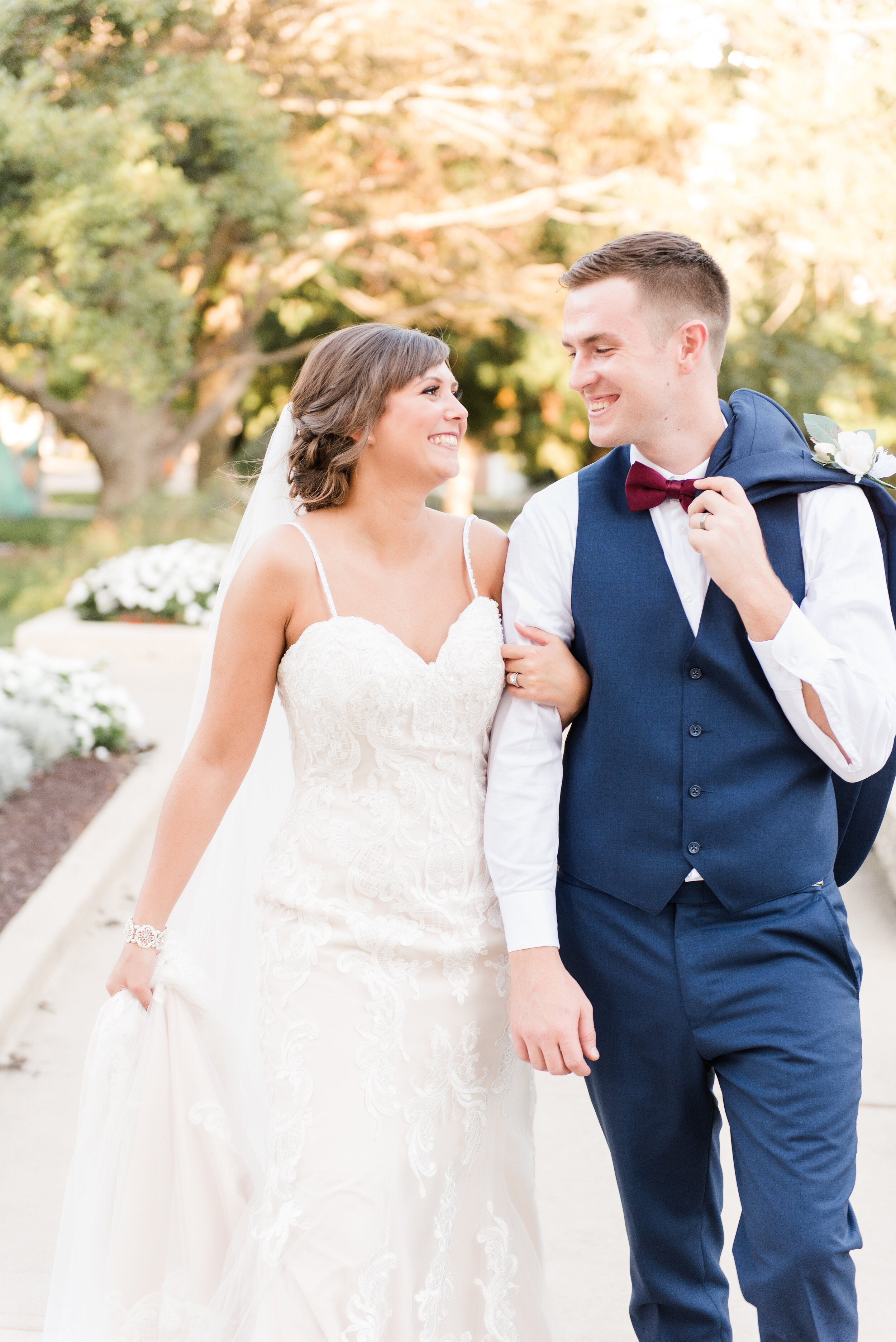 bride and groom walking on illinois state university campus