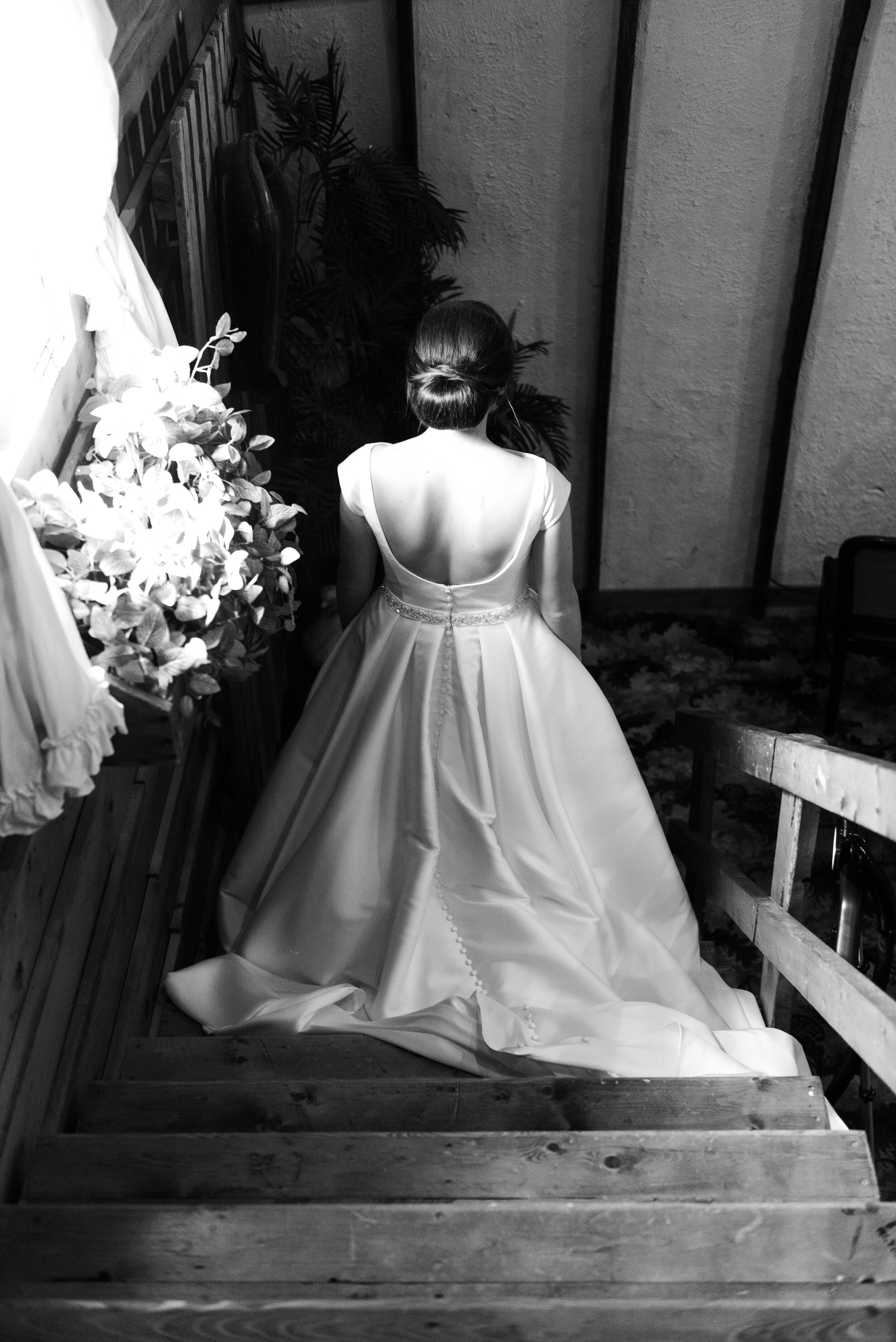black and white portrait bride going down the stairs