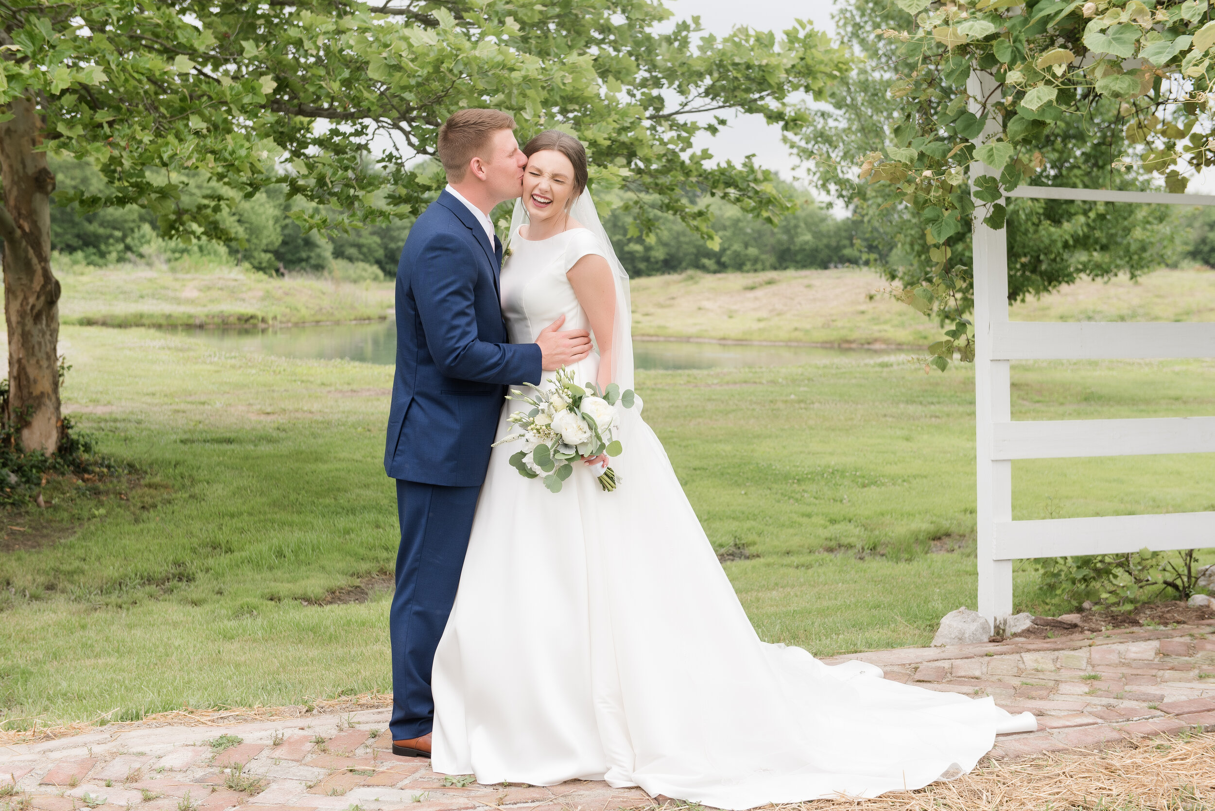 bride laughing in vineyard