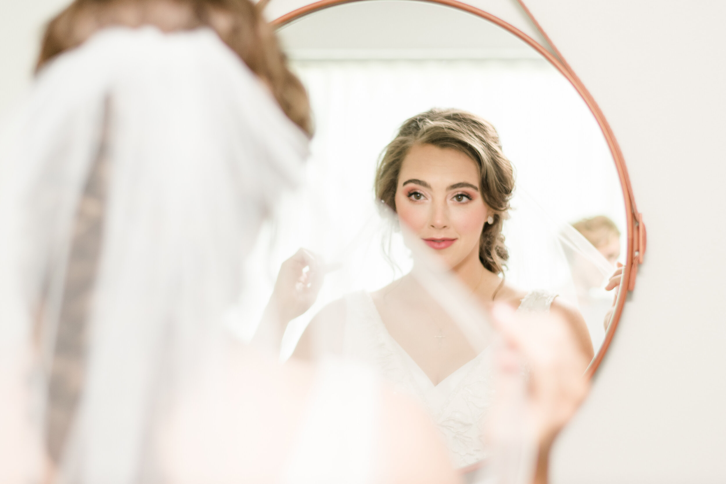 bride looking in mirror getting ready- state house inn in springfield illinois