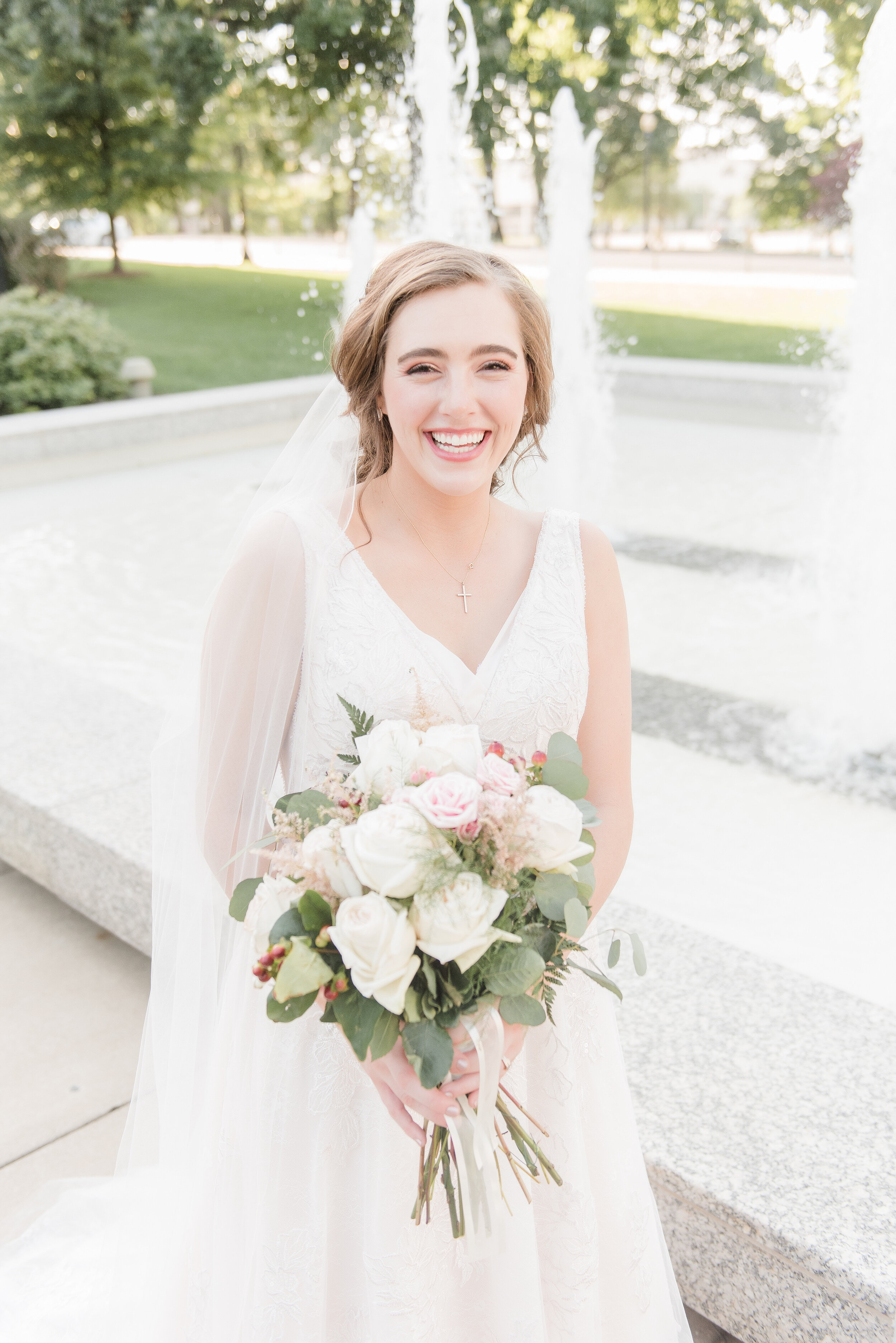 bride laughing by fountains at state capitol building in Springfield, Illinois