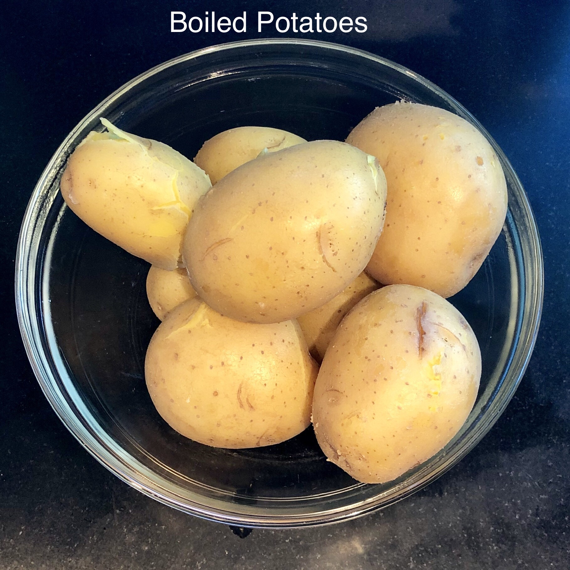 9. Boil the potatoes with skins on. Be careful not to overcook them. If they're different sizes, you may have to remove the smaller ones before the larger ones, as they will cook more quickly. Test them with a fork to check their progress.