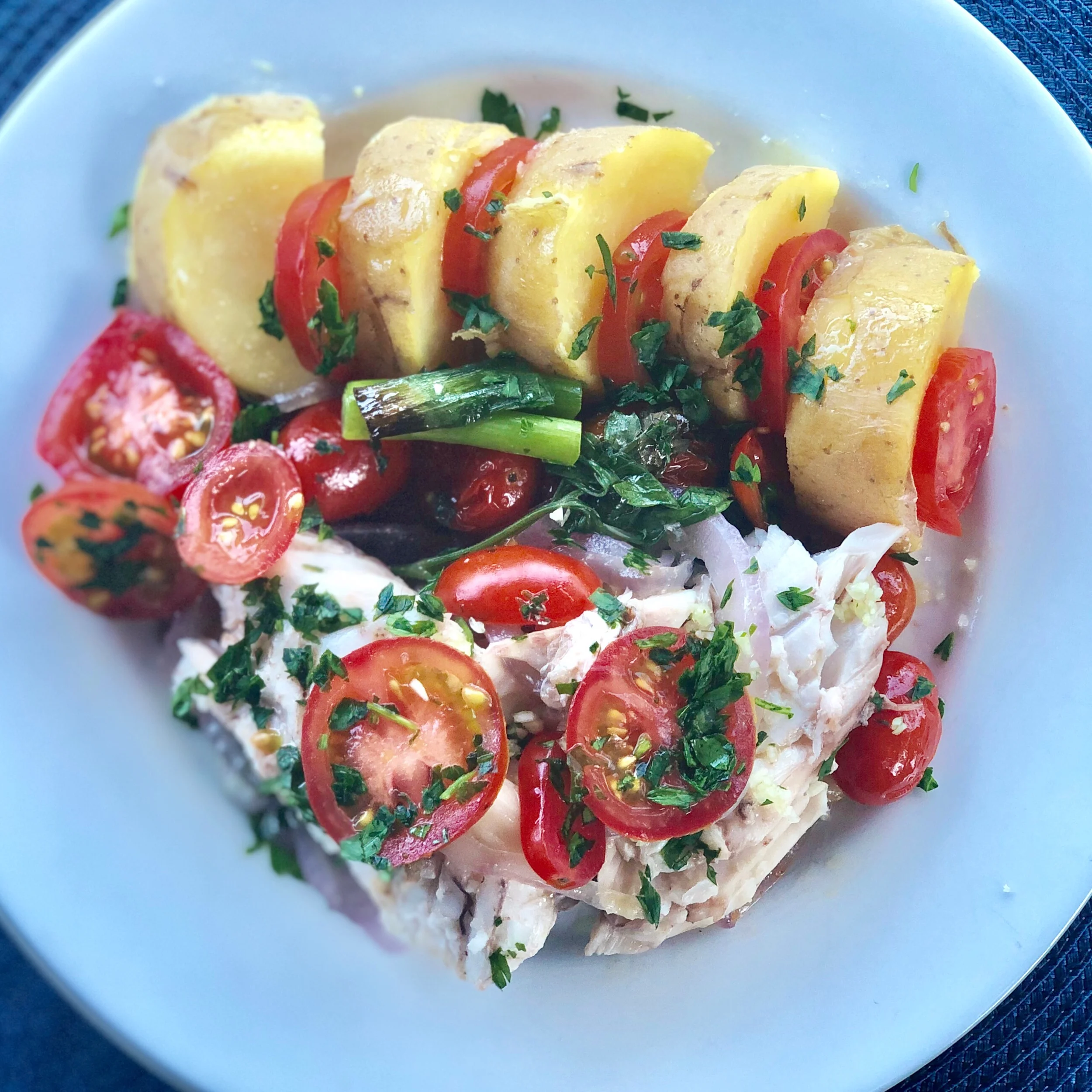 Serve with potatoes, sliced tomatoes and sprinkle with minced garlic and parsley, and some lemon slices.