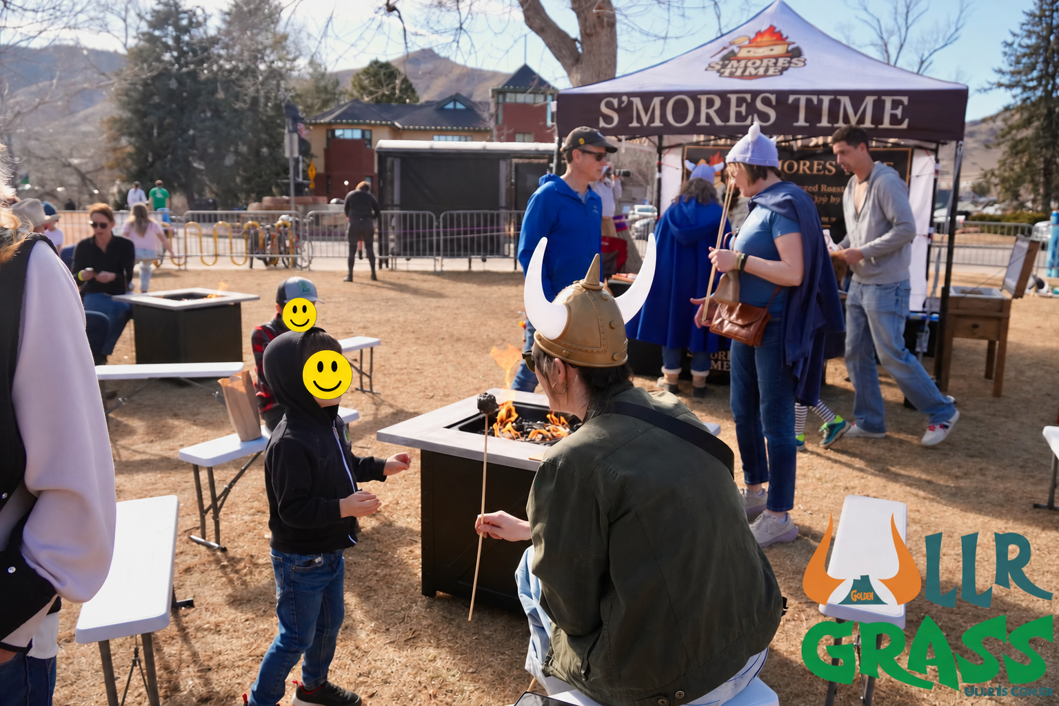 Person wearing Viking helmet roasting marshmallow over fire pit at outdoor food festival.