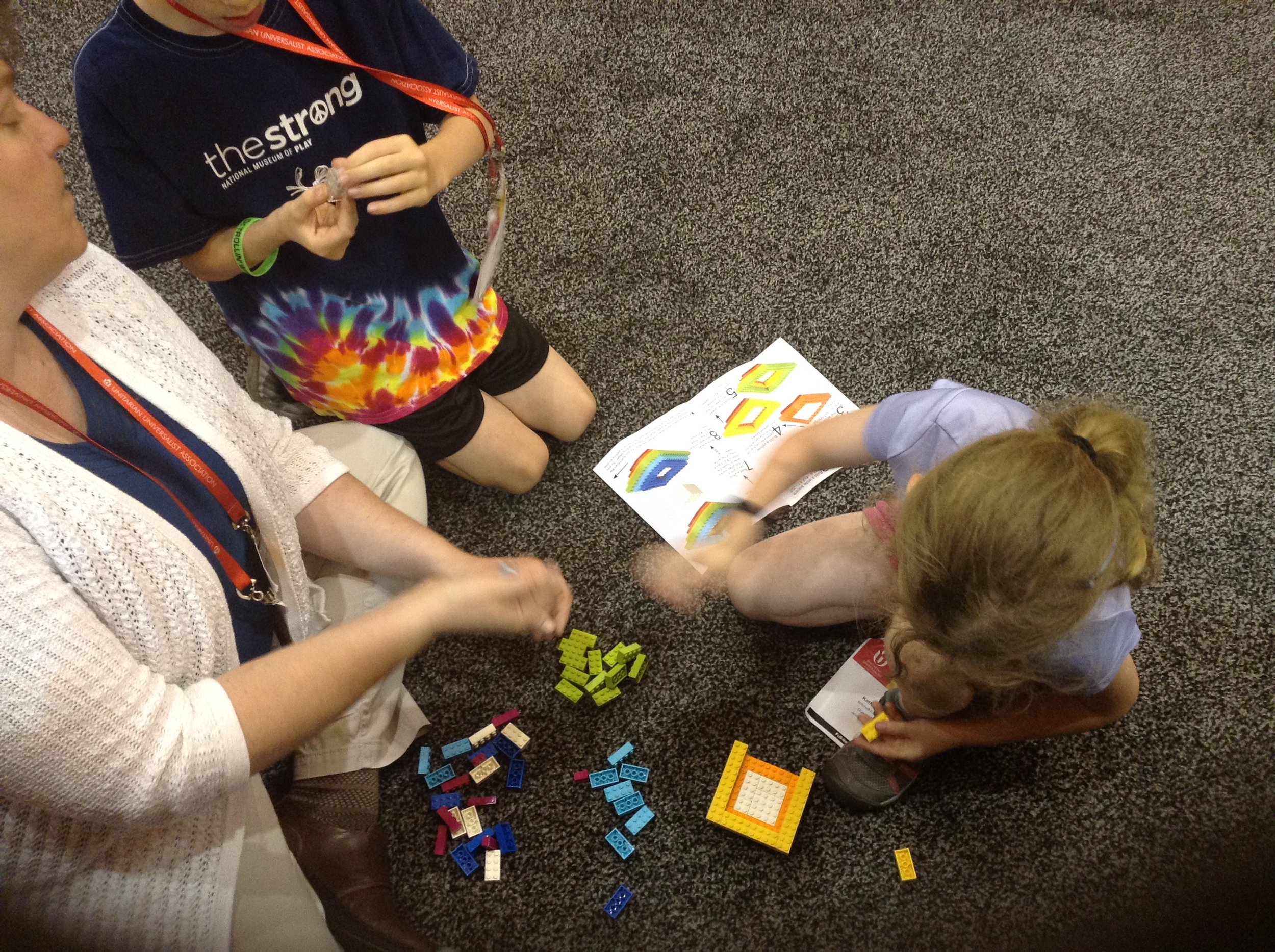 At the 2017 Unitarian Universalist General Assembly, the LEGO Chalice was a hit with kids of all ages. Here is a family taking a break, building the LEGO Chalice at my husband's (UU sculptor Brian Watson) booth.