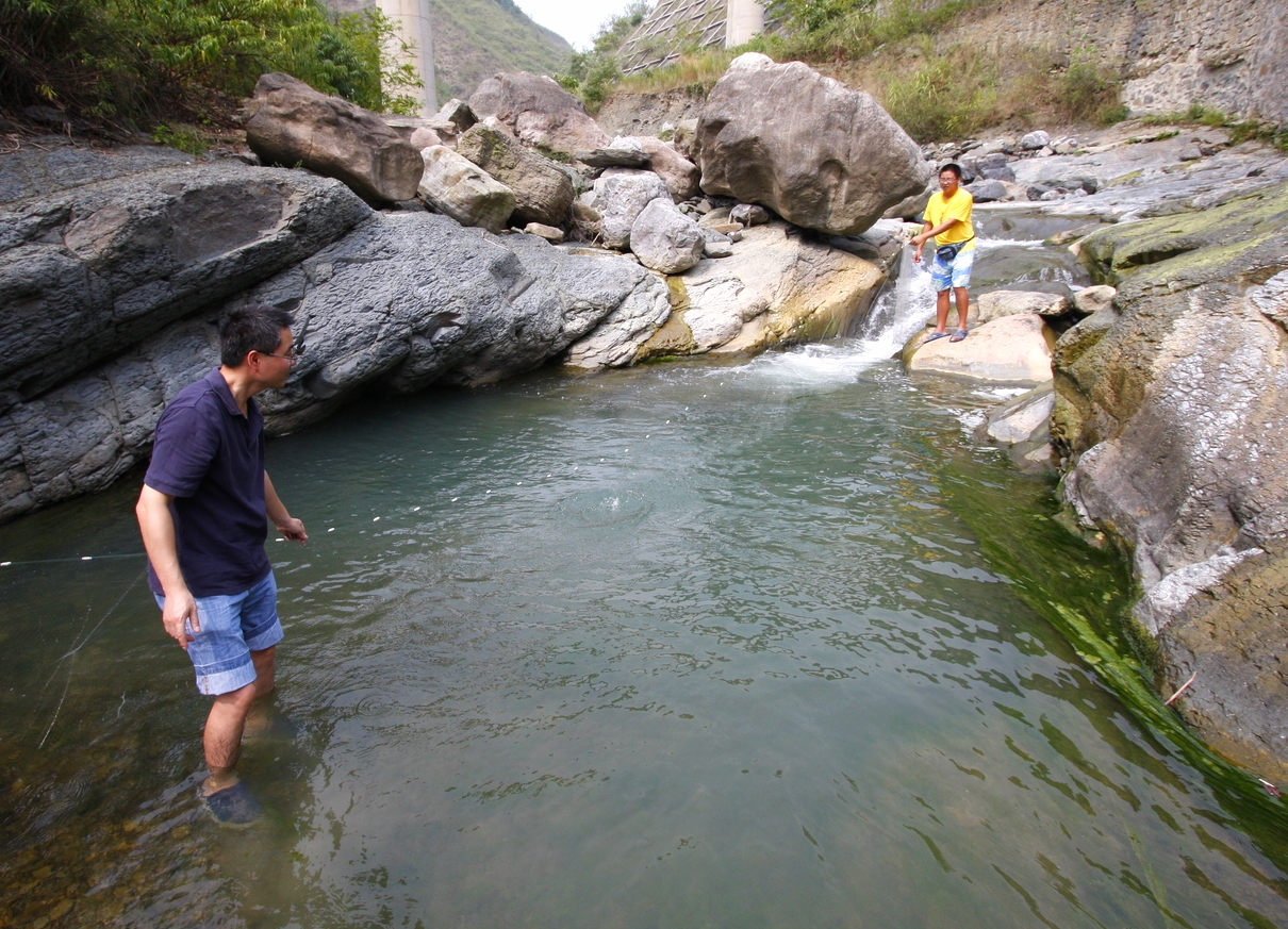 Capturing fish from a stream outside of Chongqing, China.