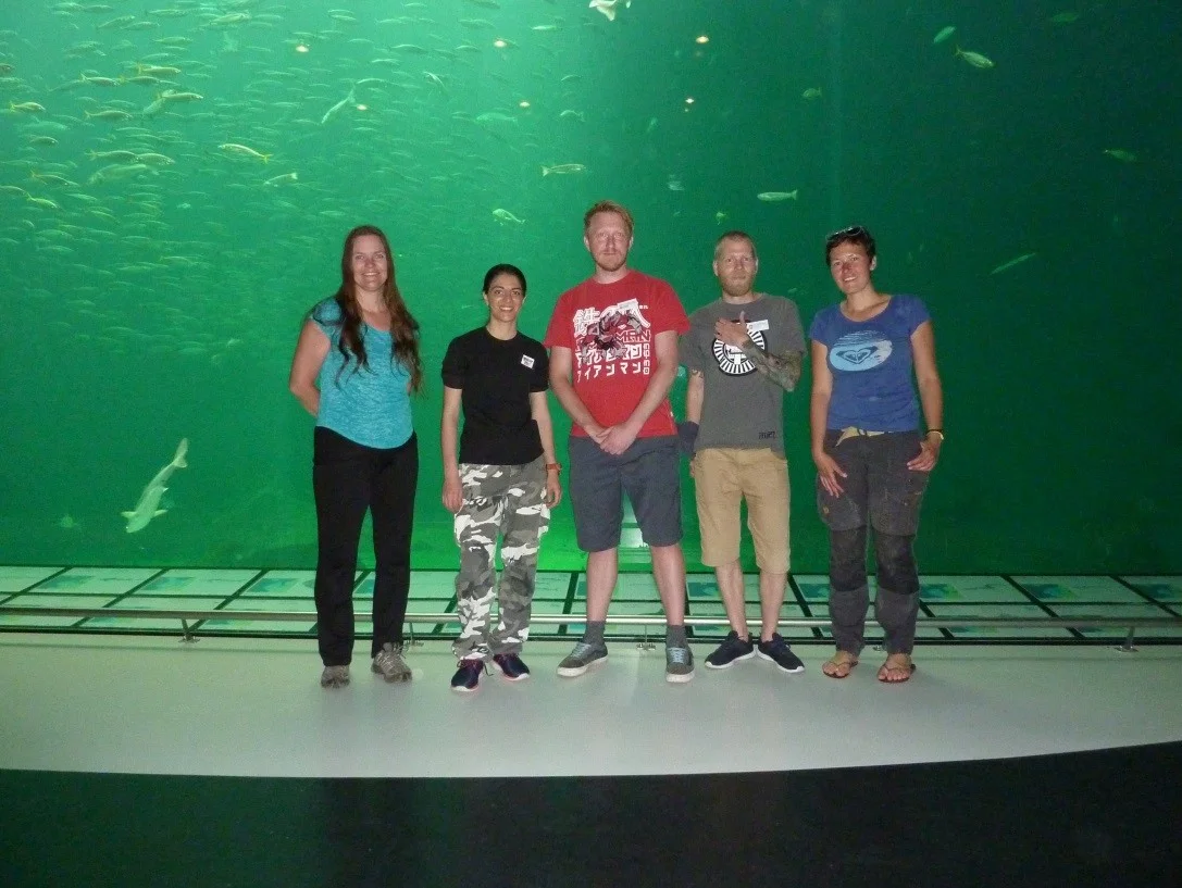Some of the team posing in front of the big pelagic aquarium.