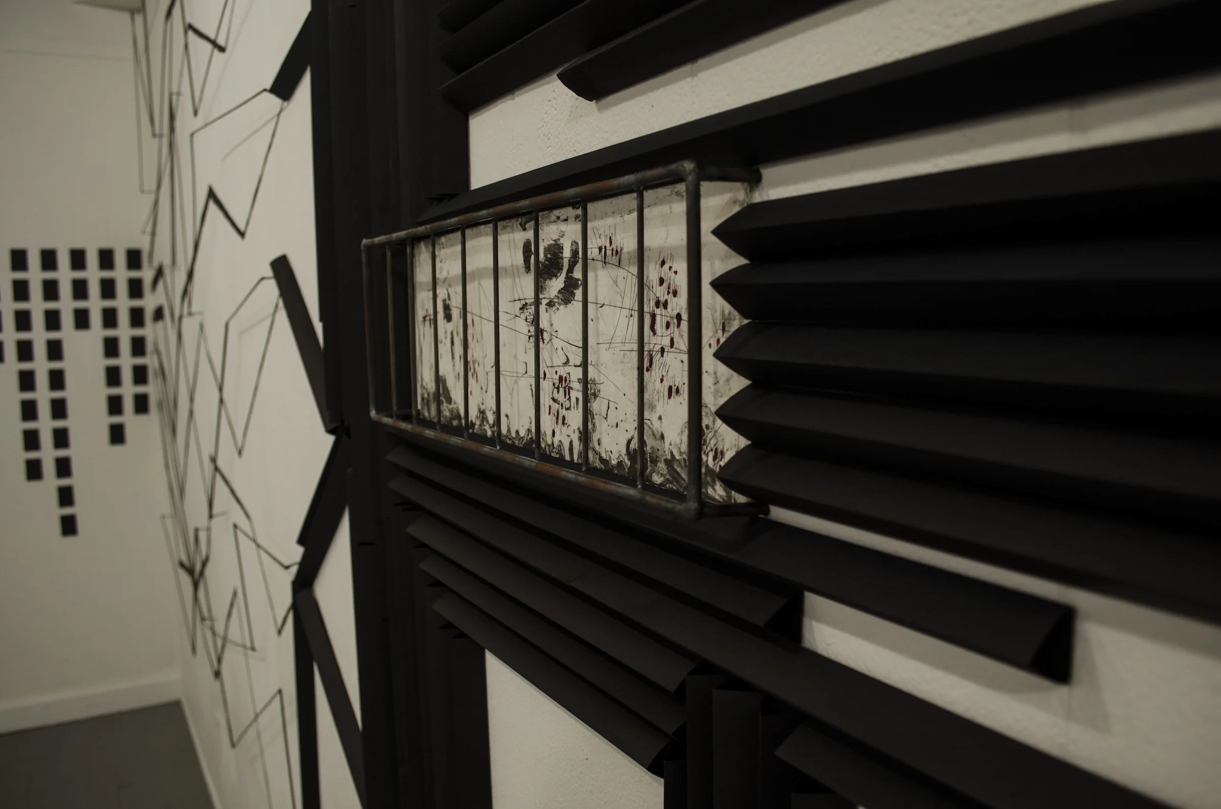 Detail of welded cage around a copper etching surrounded by folded paper elements