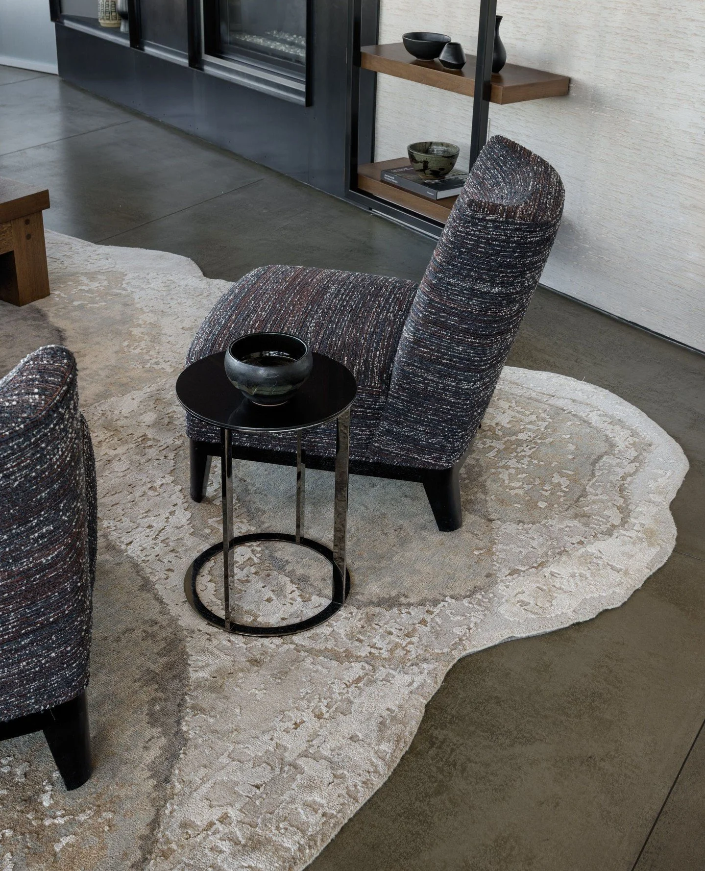 To define rooms within the open angular plan we added a large custom amoeba-shaped rug in the living room of our Belltown Loft Project to anchor the space. It was really a leap of faith for the client to let us run with the uncommon rug shape, buy af